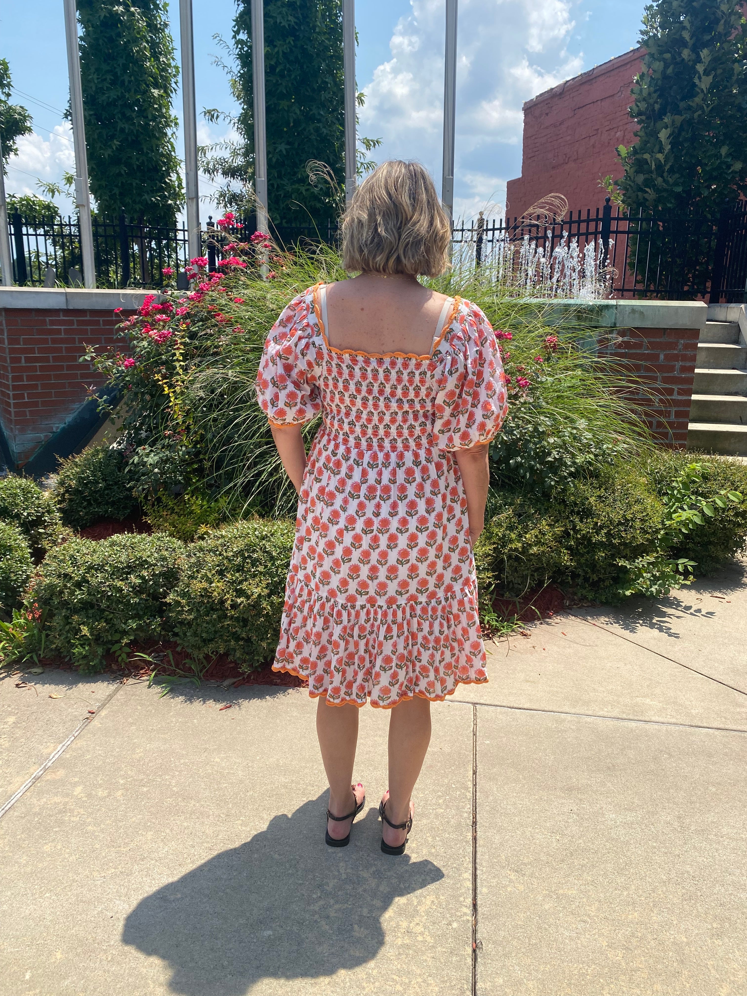 Smocked back bodice, orange trim, ruffle hem detail