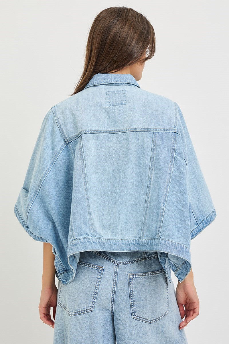Light blue denim jacket worn by a person on a white background