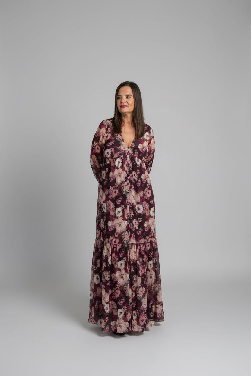 Woman smiling outside Spirit & Wind Boutique storefront wearing burgundy floral button-down maxi dress, lifestyle outdoor shot
