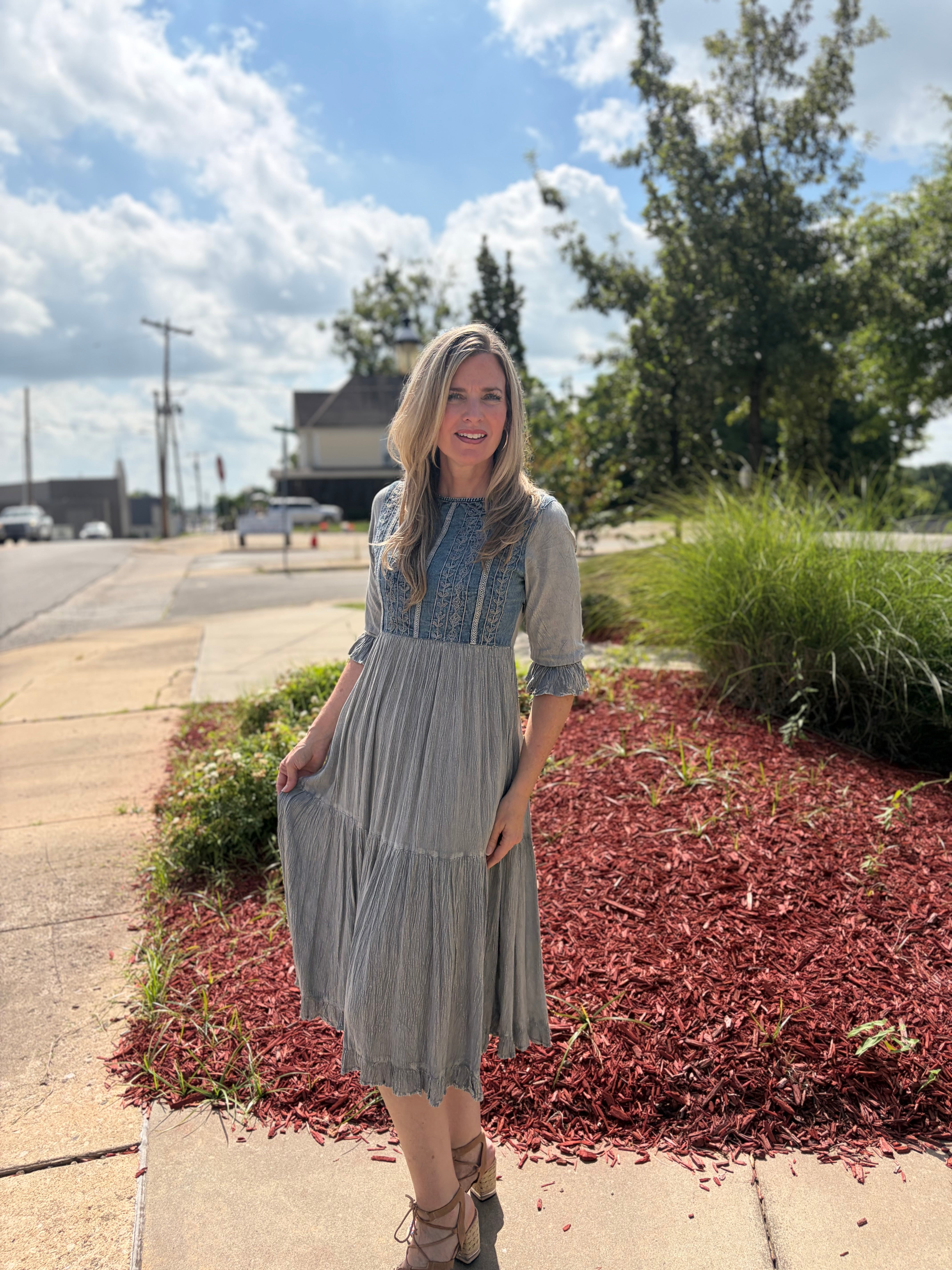 Grey stonewashed tiered midi dress with denim yoke and lace detailing styled with strappy heels