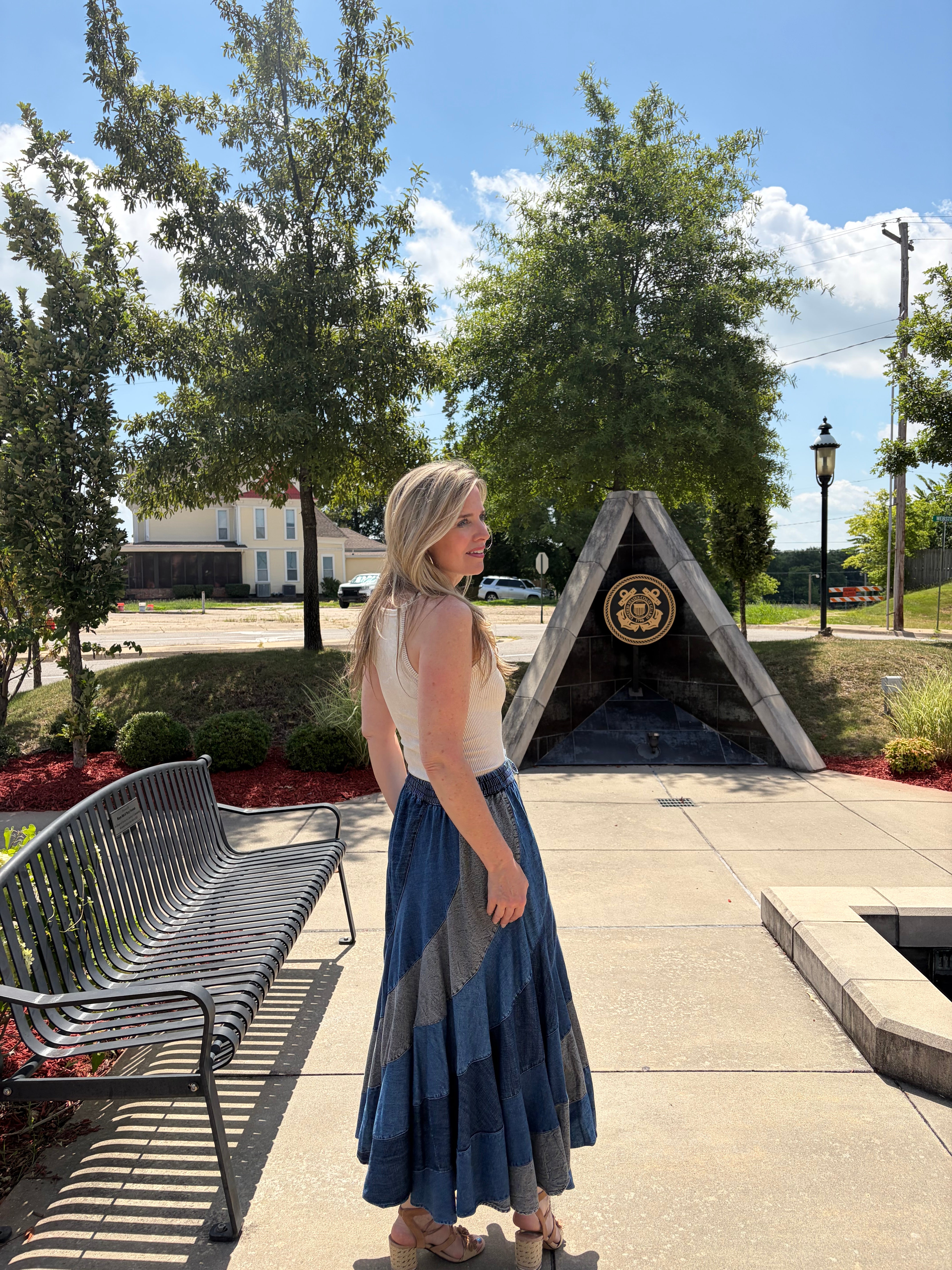 Side profile, model looking away, showcasing the skirt's bias-cut drape and movement