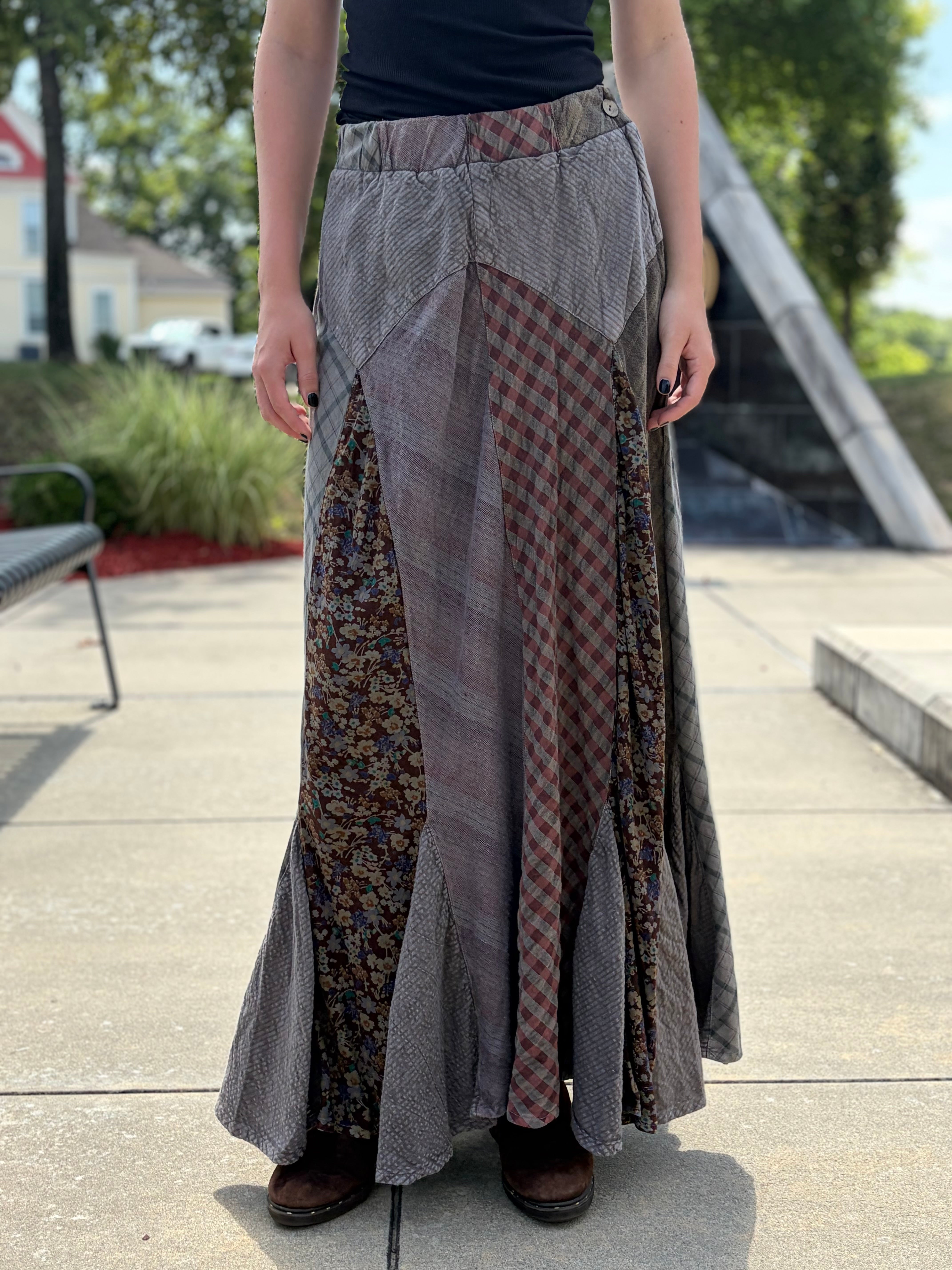Close-up front view of Montana patchwork maxi skirt highlighting mixed plaid houndstooth and floral fabric panels with elasticated waist and flared ruffled hem