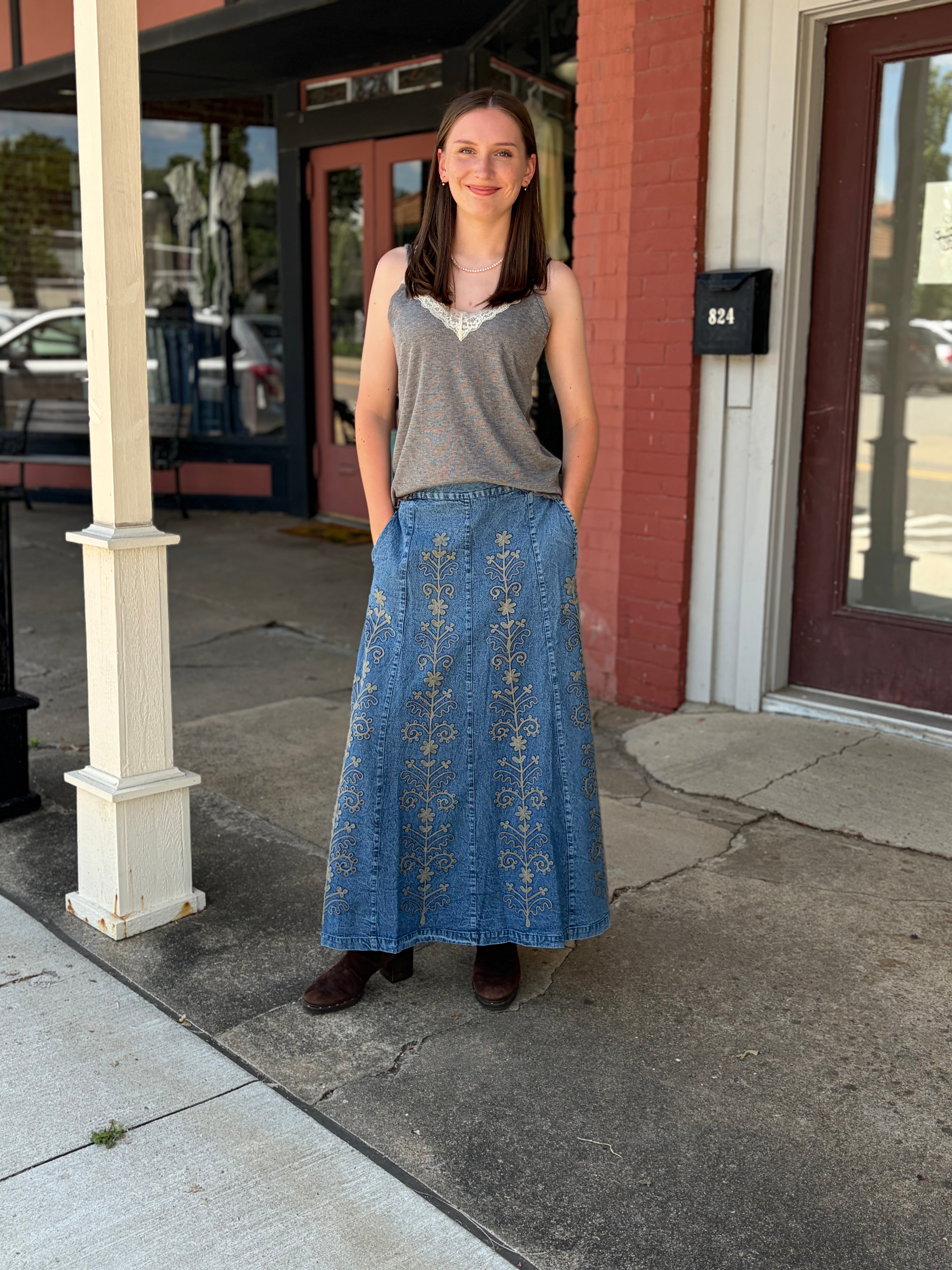 Outdoor full-body front, smiling model, gray cami + brown boots