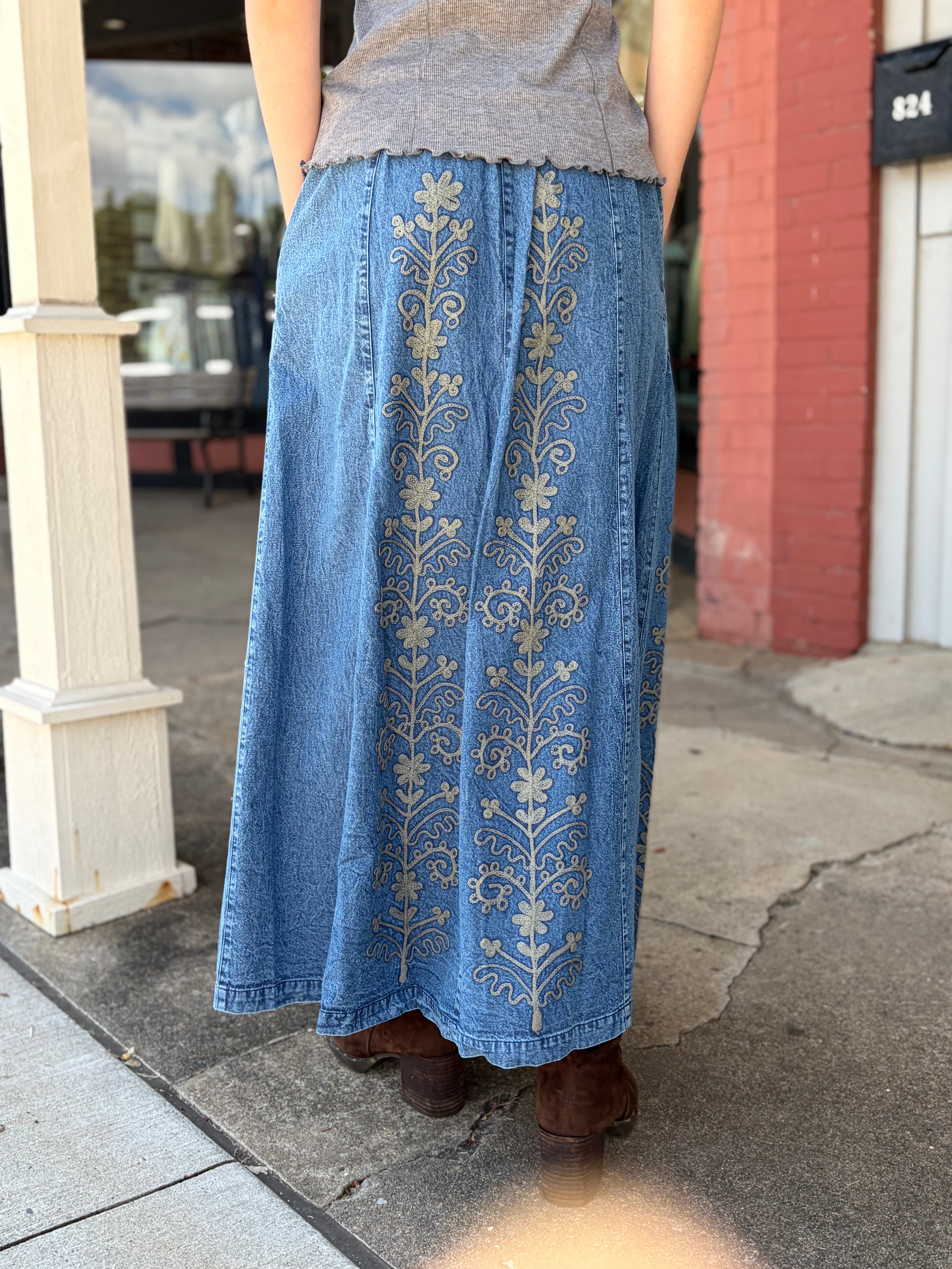Outdoor back view, full embroidery coverage across the skirt