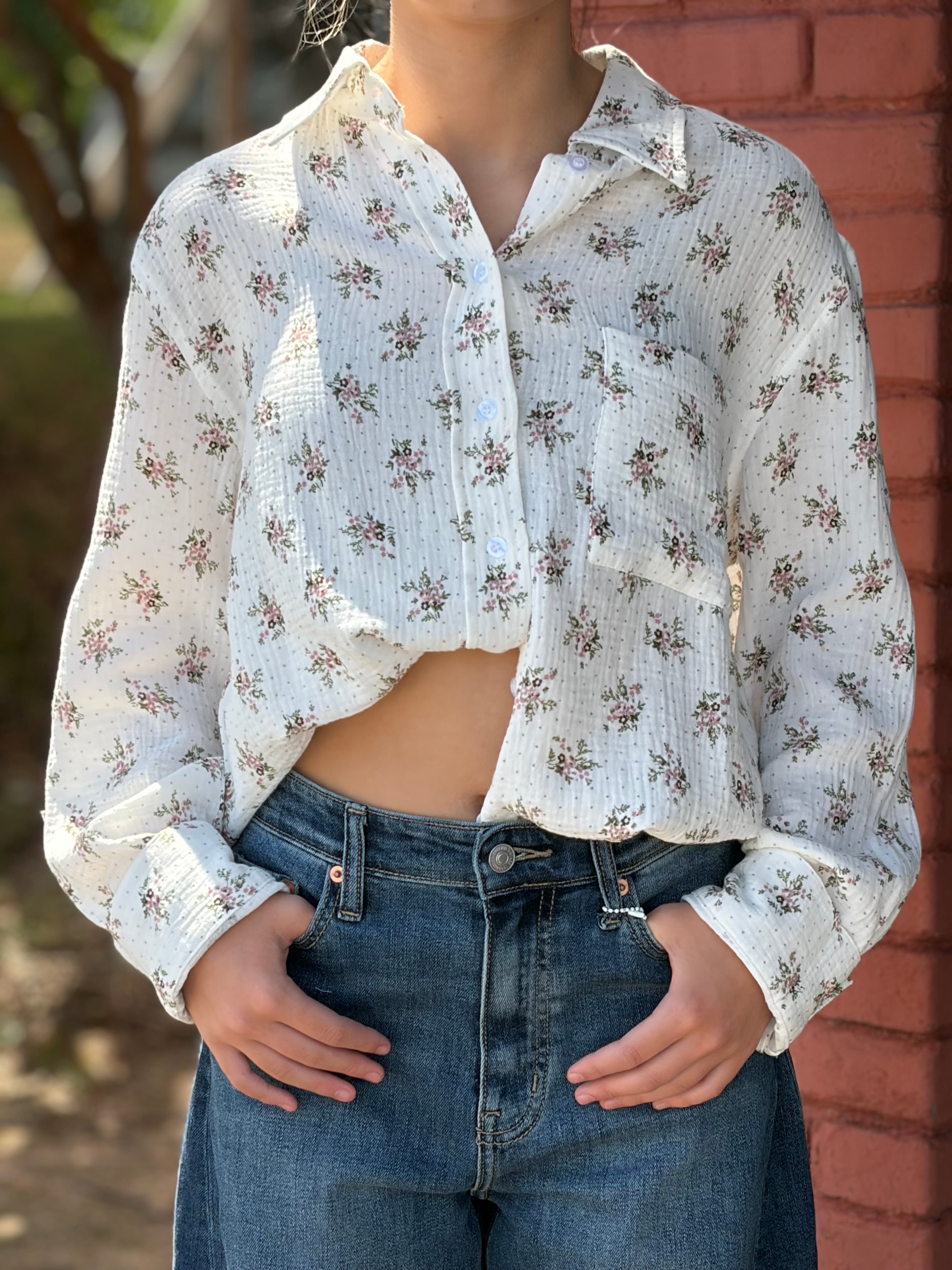 Close-up detail of chest pocket, sheer gauze, and floral print