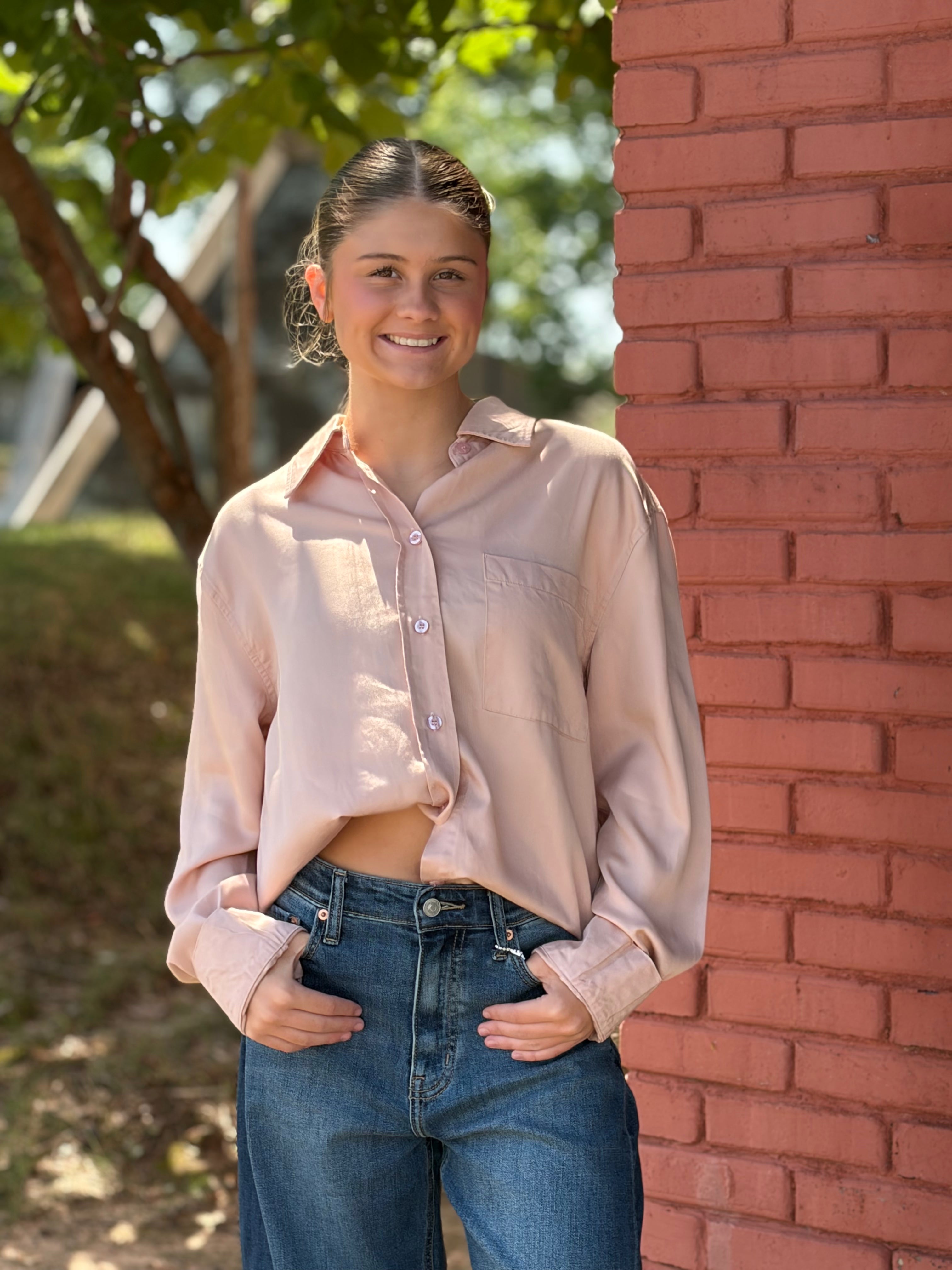 Front view, Pink button down, smiling model outdoors