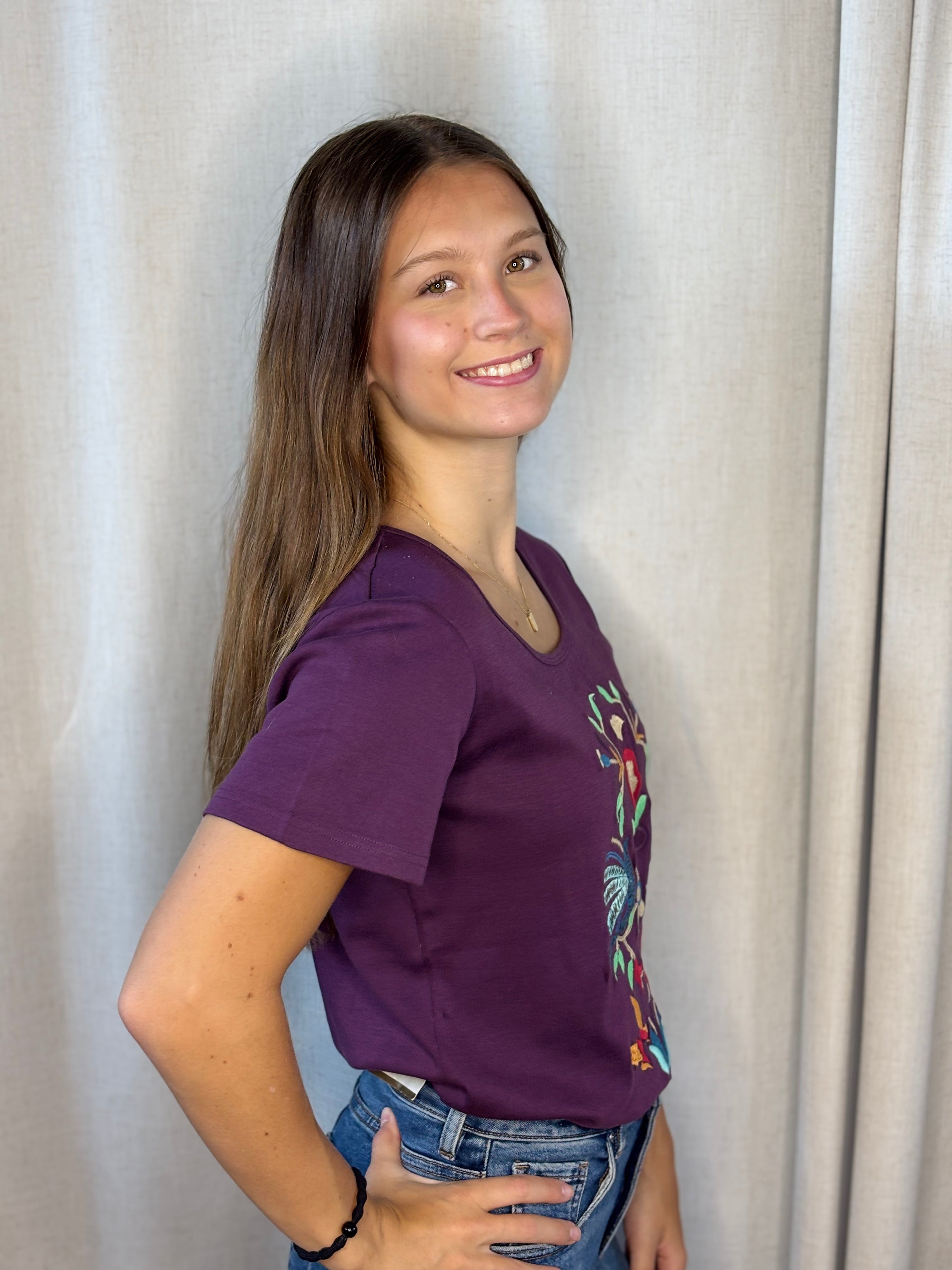 Anü Birds & Butterflies Embroidered Tee in plum — side profile showing relaxed fit, short sleeves, and embroidery detail