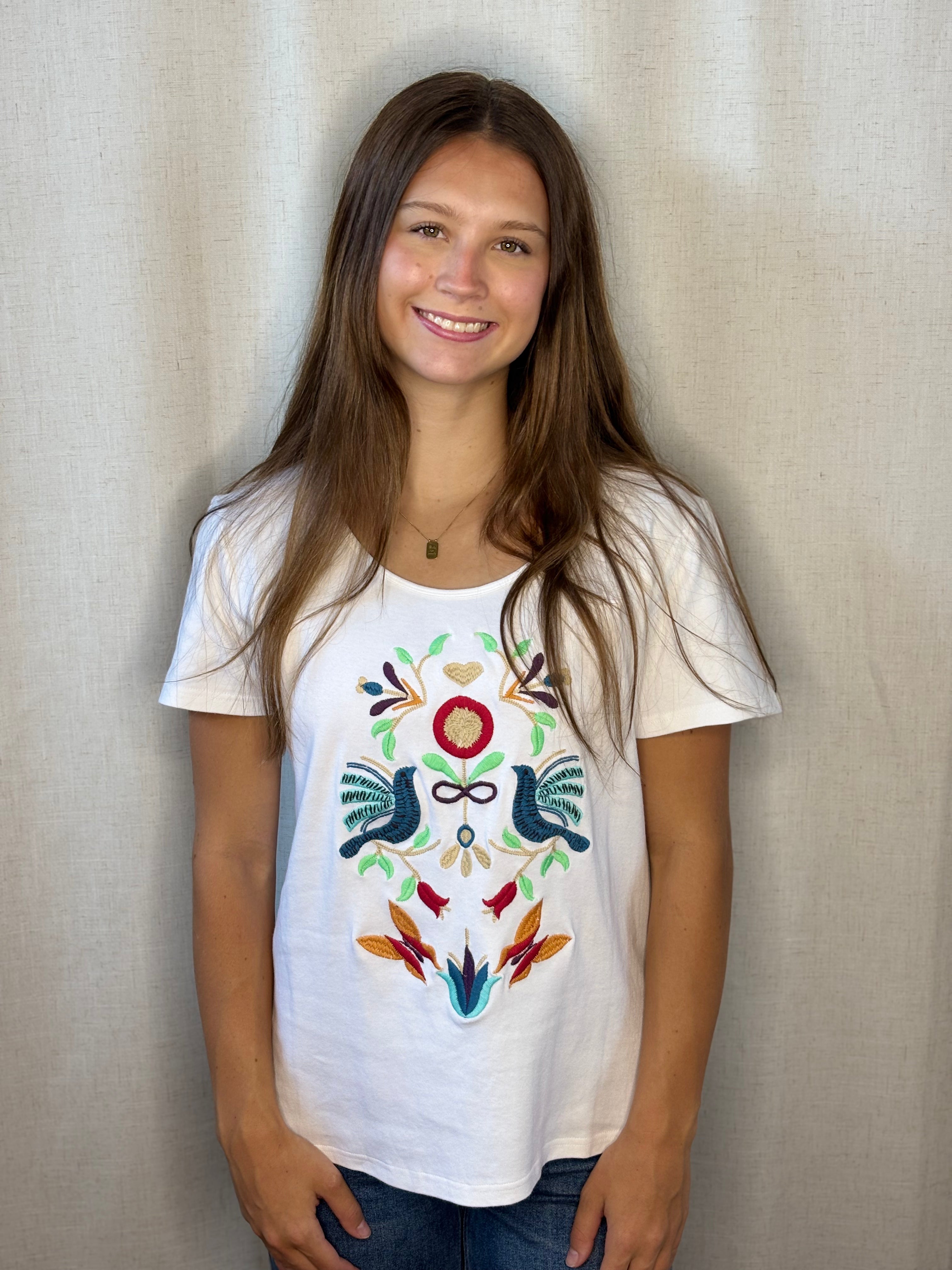 Anü Birds & Butterflies Embroidered Tee in white — front view with colorful folk-art bird and floral embroidery on 100% cotton tee
