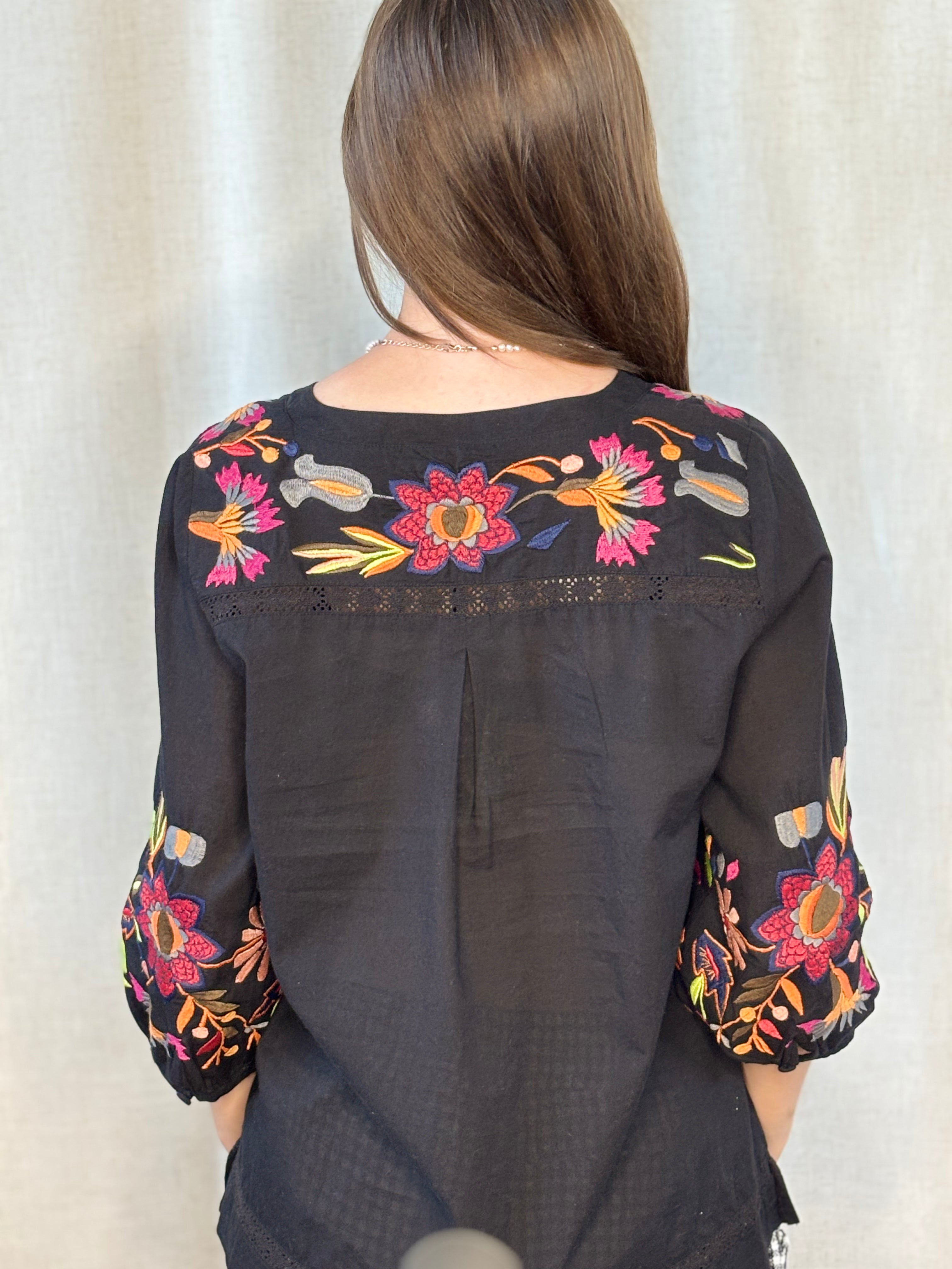 Anü Vibrant Floral Embroidered Blouse in black — back view showing floral embroidery across yoke and sleeves with lace trim detail