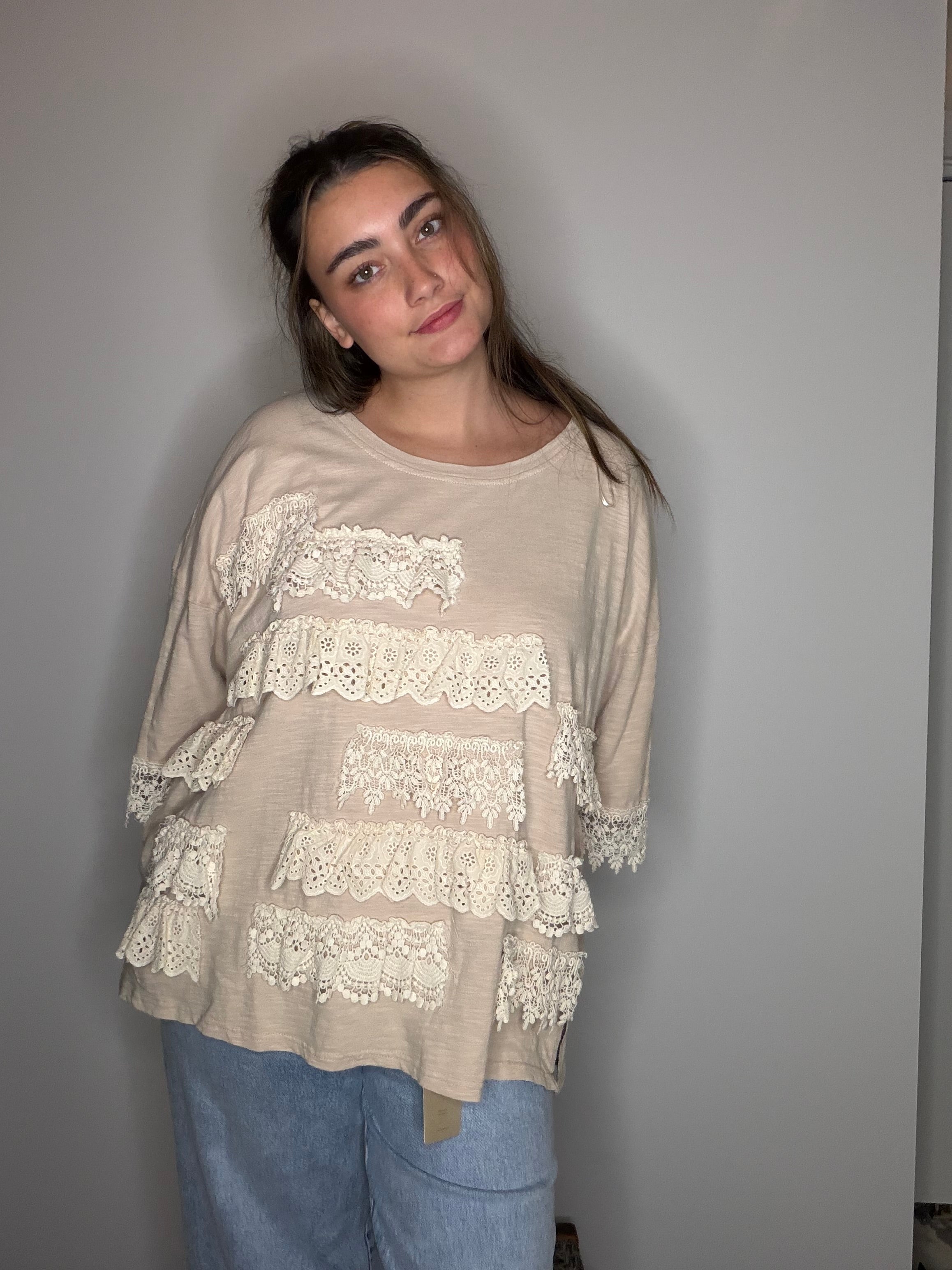 Three-quarter front: layered eyelet and crochet lace from neckline to hem