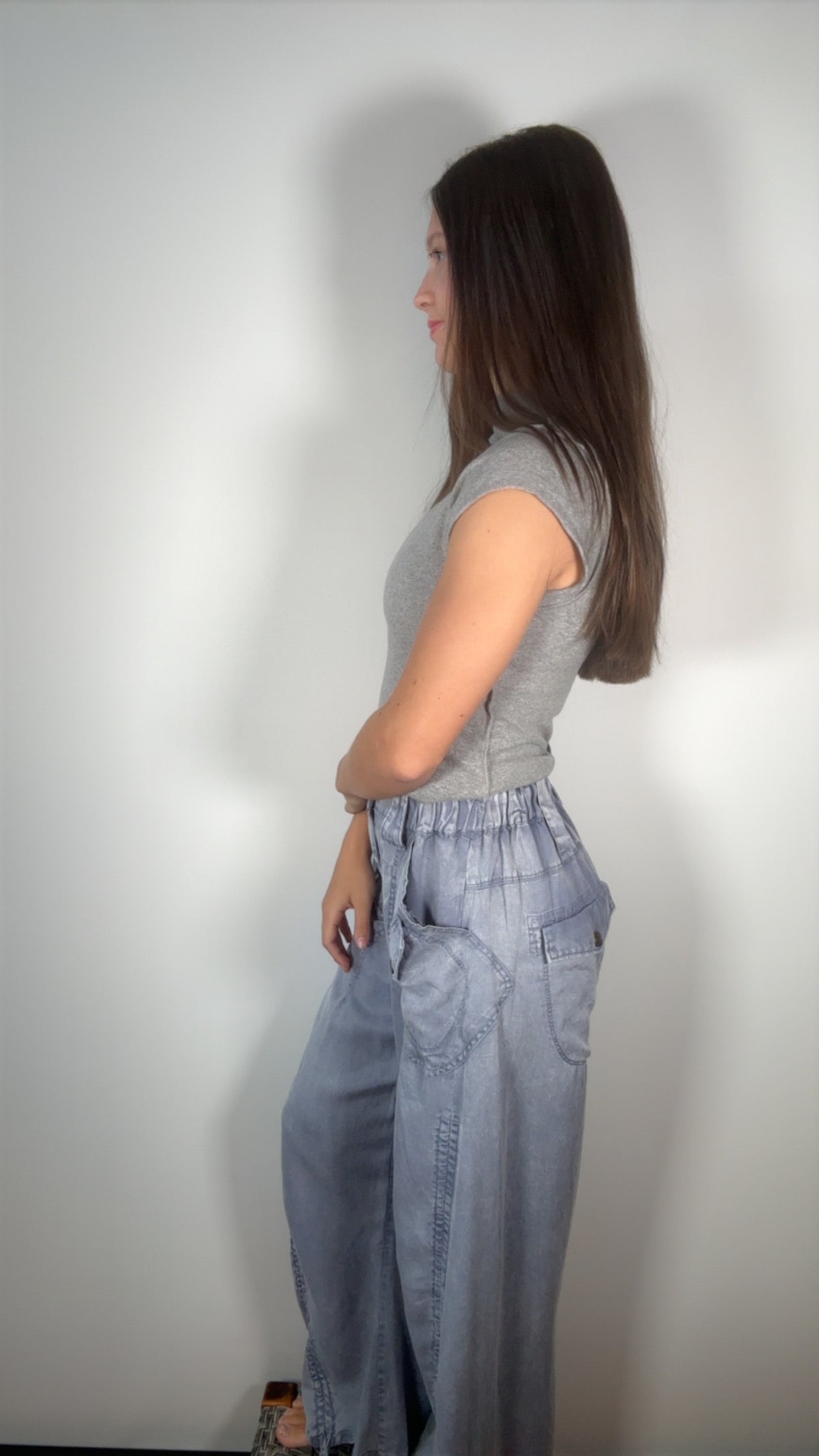 side profile showing the elastic back waist and wide-leg silhouette