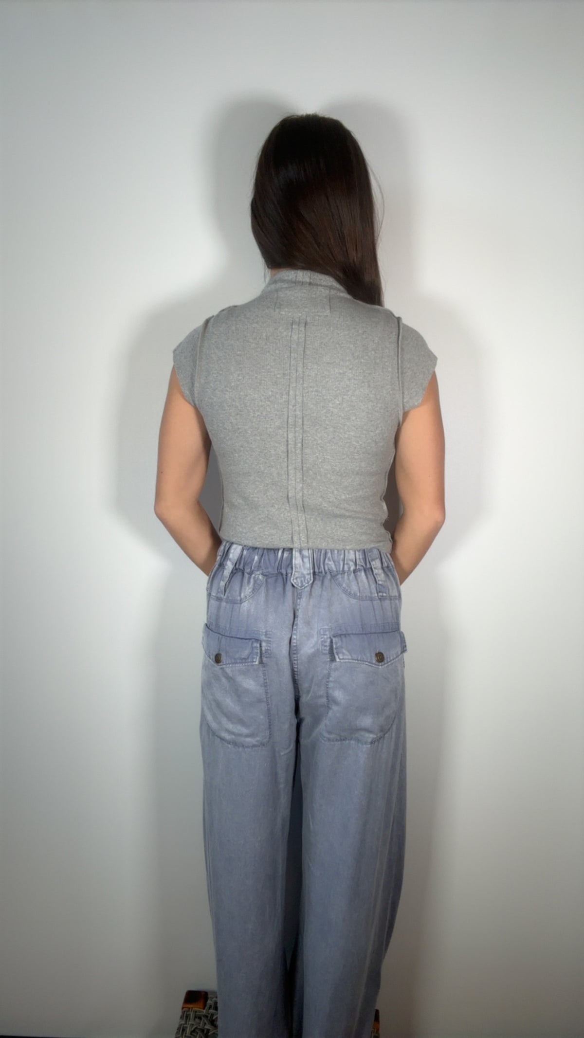 back view highlighting the elastic waistband and button-flap pockets