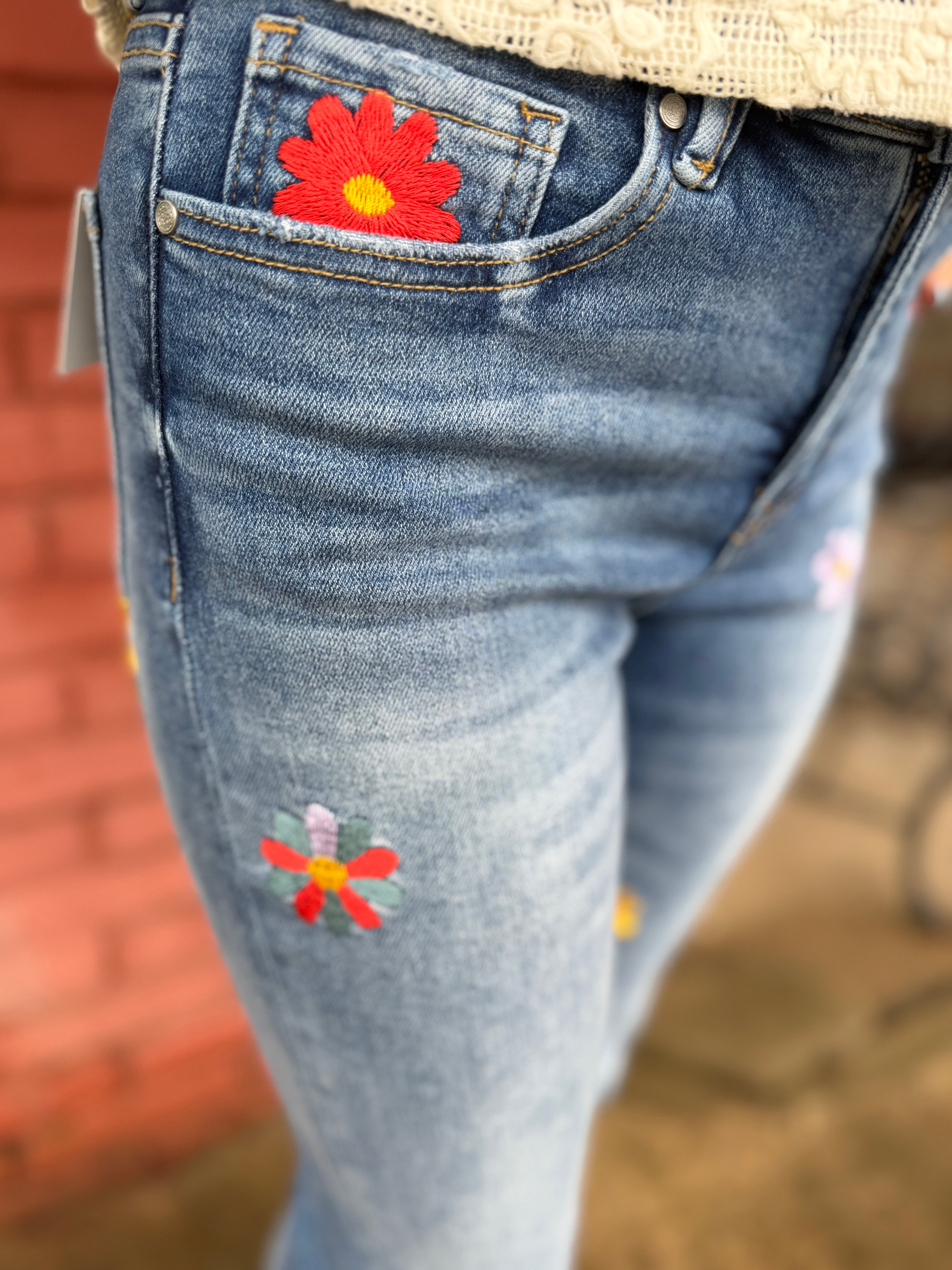 Close up view of Flower Embroidered Mid Rise Bootcut Jeans in Medium Blue
