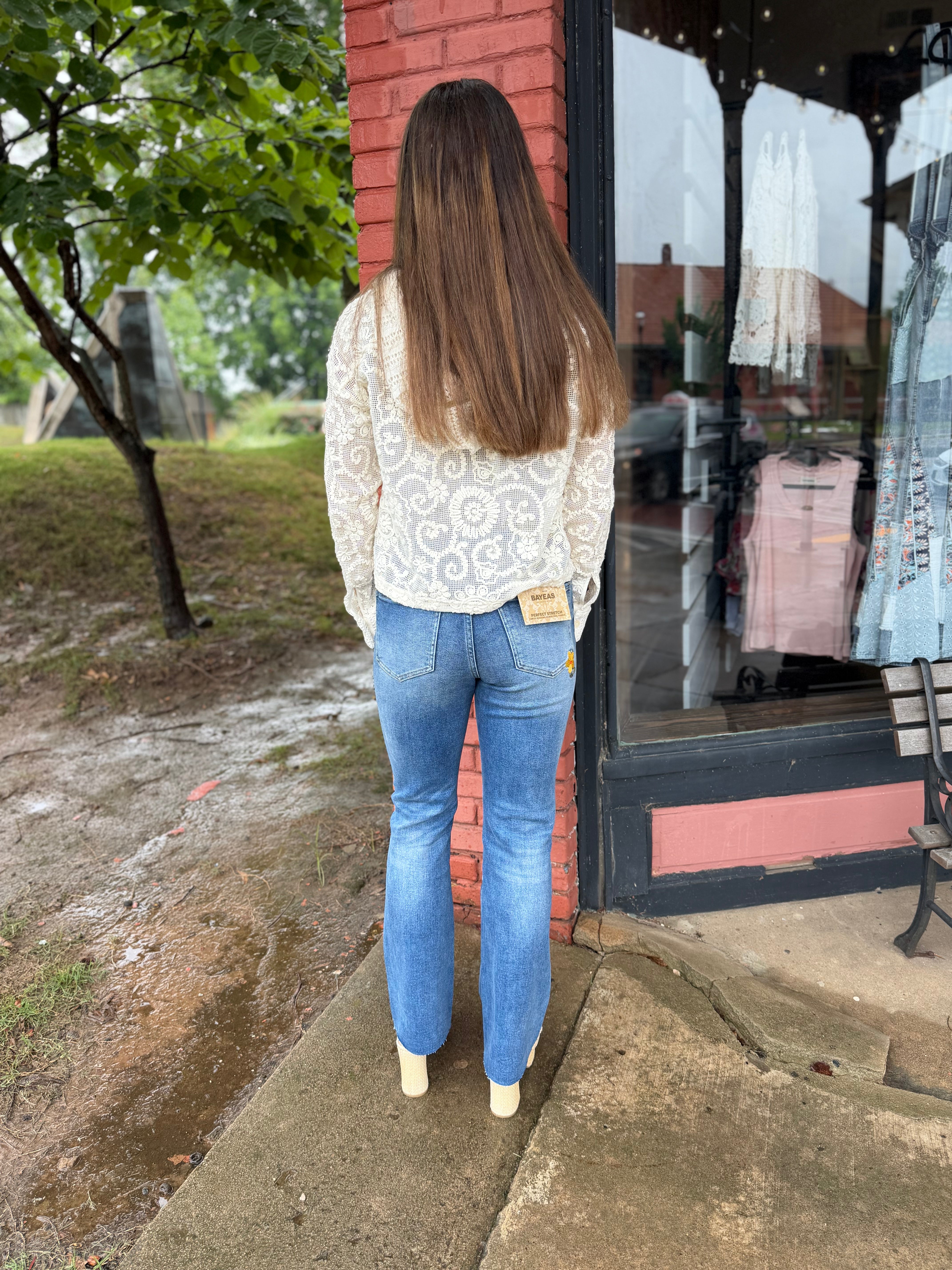 Back view of Flower Embroidered Mid Rise Bootcut Jeans in Medium Blue