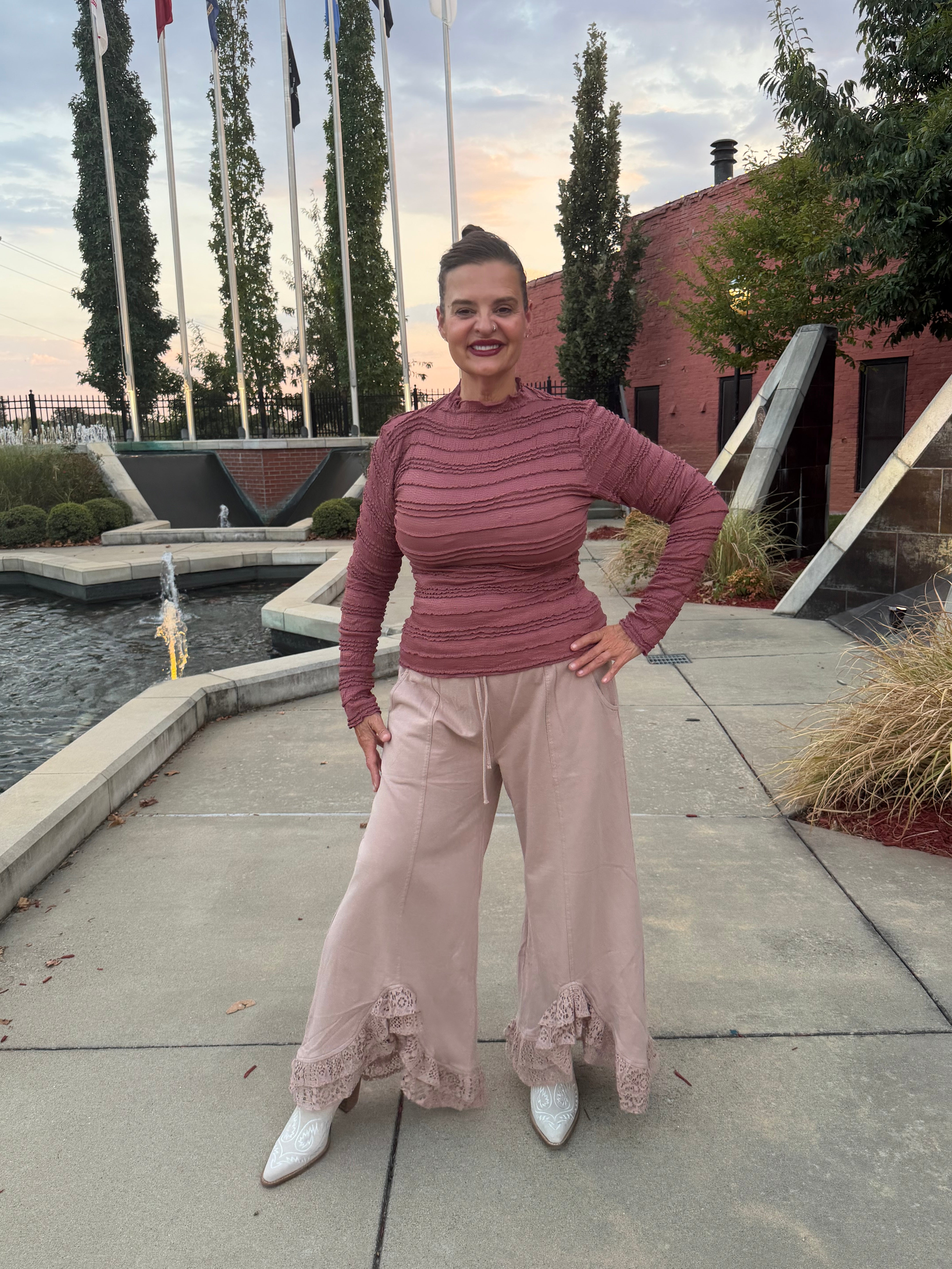 Full length view of Romantic Lace Mineral Wash Pants – Latte in a outdoor setting with model wearing a Dusty Mauve fitted ribbed top