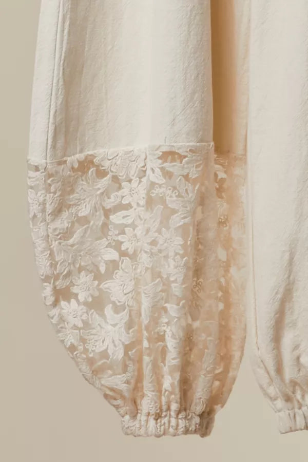 Close-up of a white lace garment on a beige background