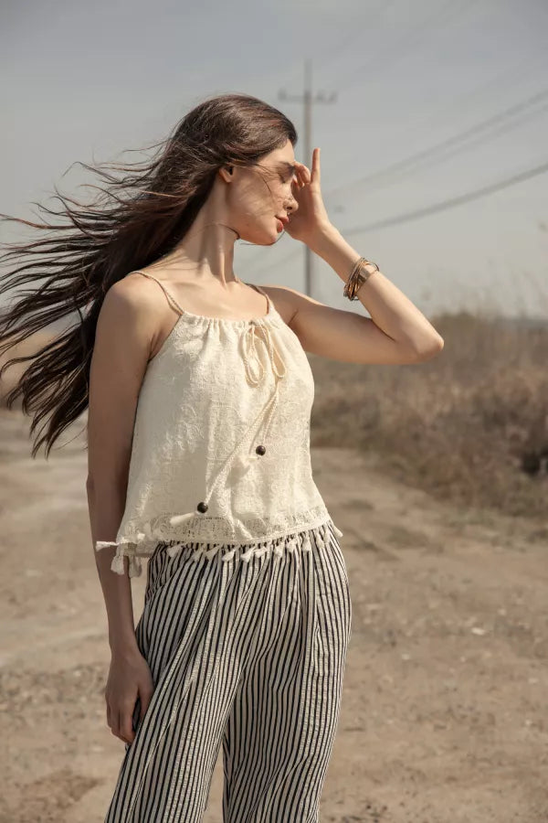 Woman wearing a cream crochet crop top 