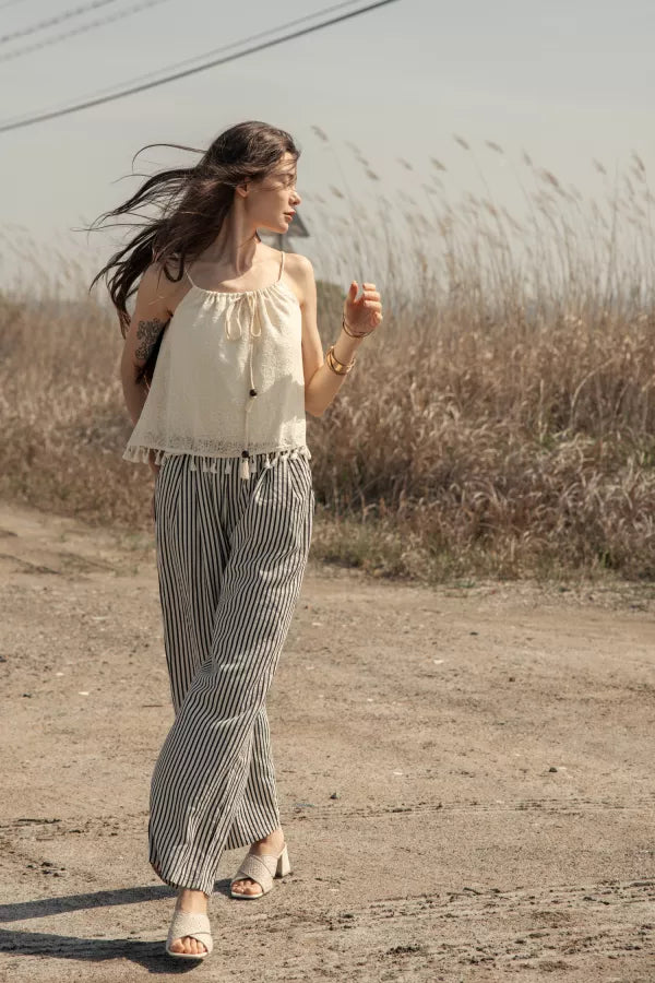 Woman wearing a cream crochet crop top 