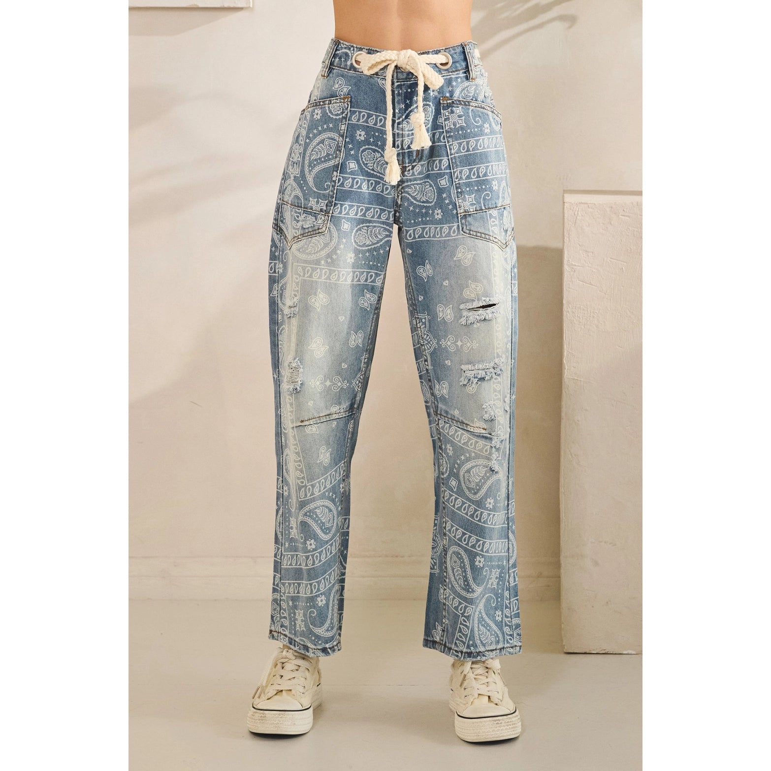 Light blue paisley-patterned pants with a drawstring on a neutral background