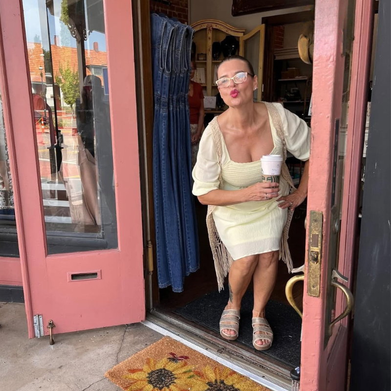 Woman standing in front of a boutique called Spirit and Wind Boutique in Van Buren, Arkansas.