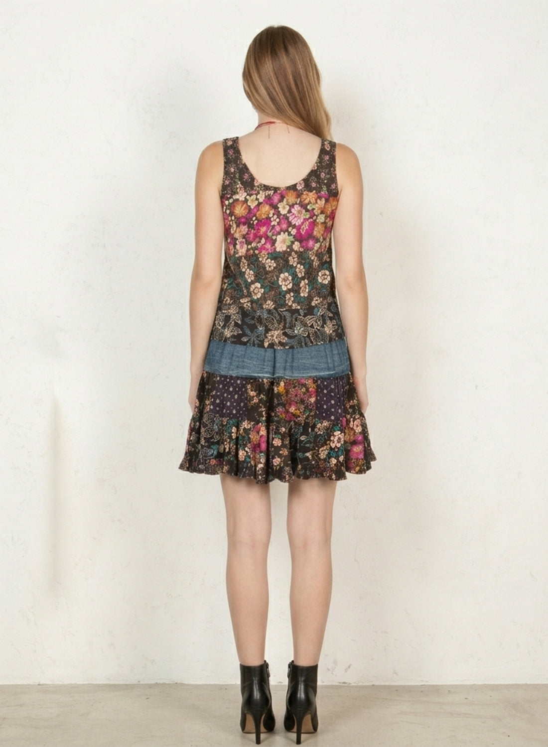 Back view of Boho Patchwork Denim Set – Sleeveless floral patchwork denim tank that has rayon print mini skirt with pockets | Spirit & Wind Boutique
