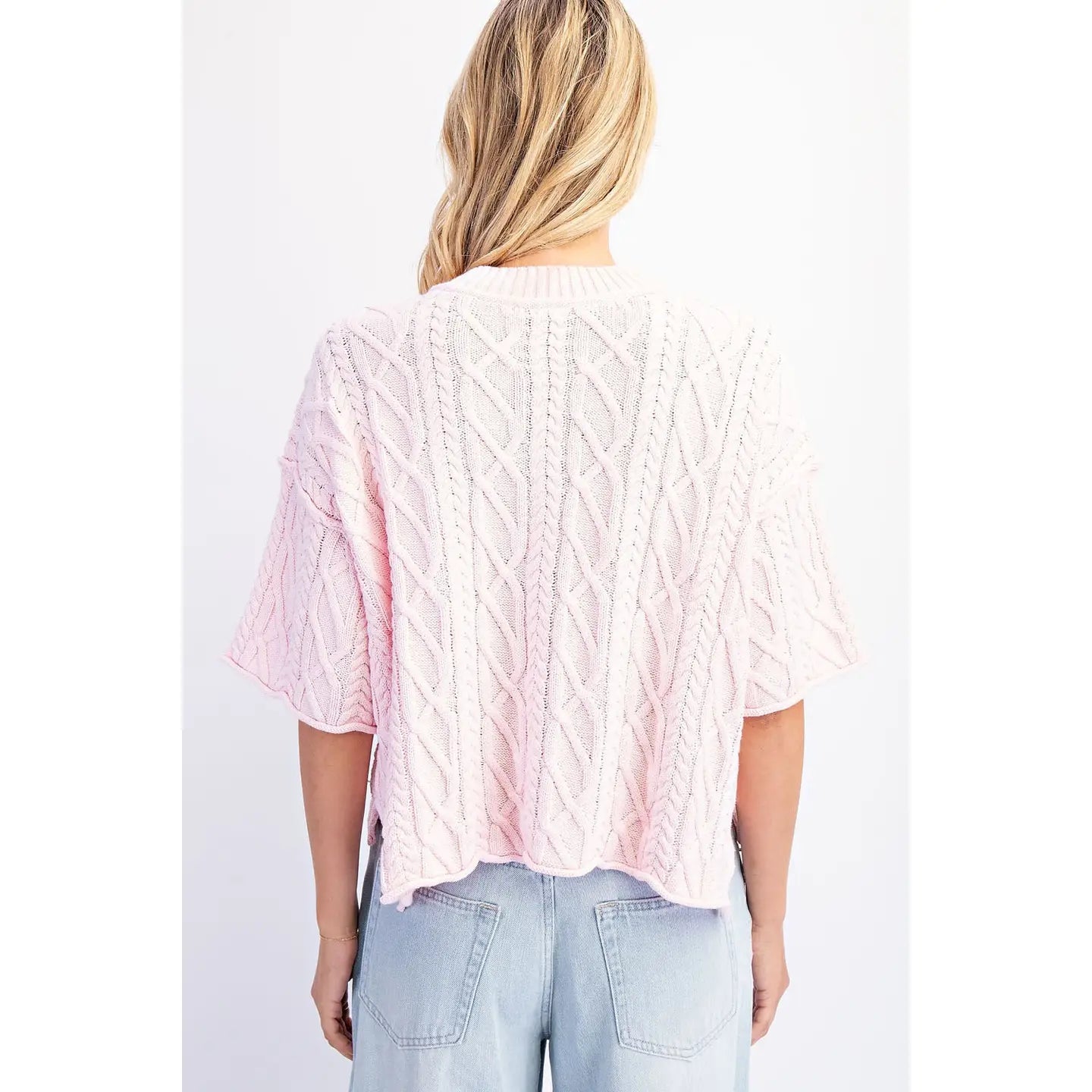Back view of The Cove Oversized Sweater in Baby Pink — front view, slouchy cable knit with dropped shoulders and asymmetrical hem in pink
