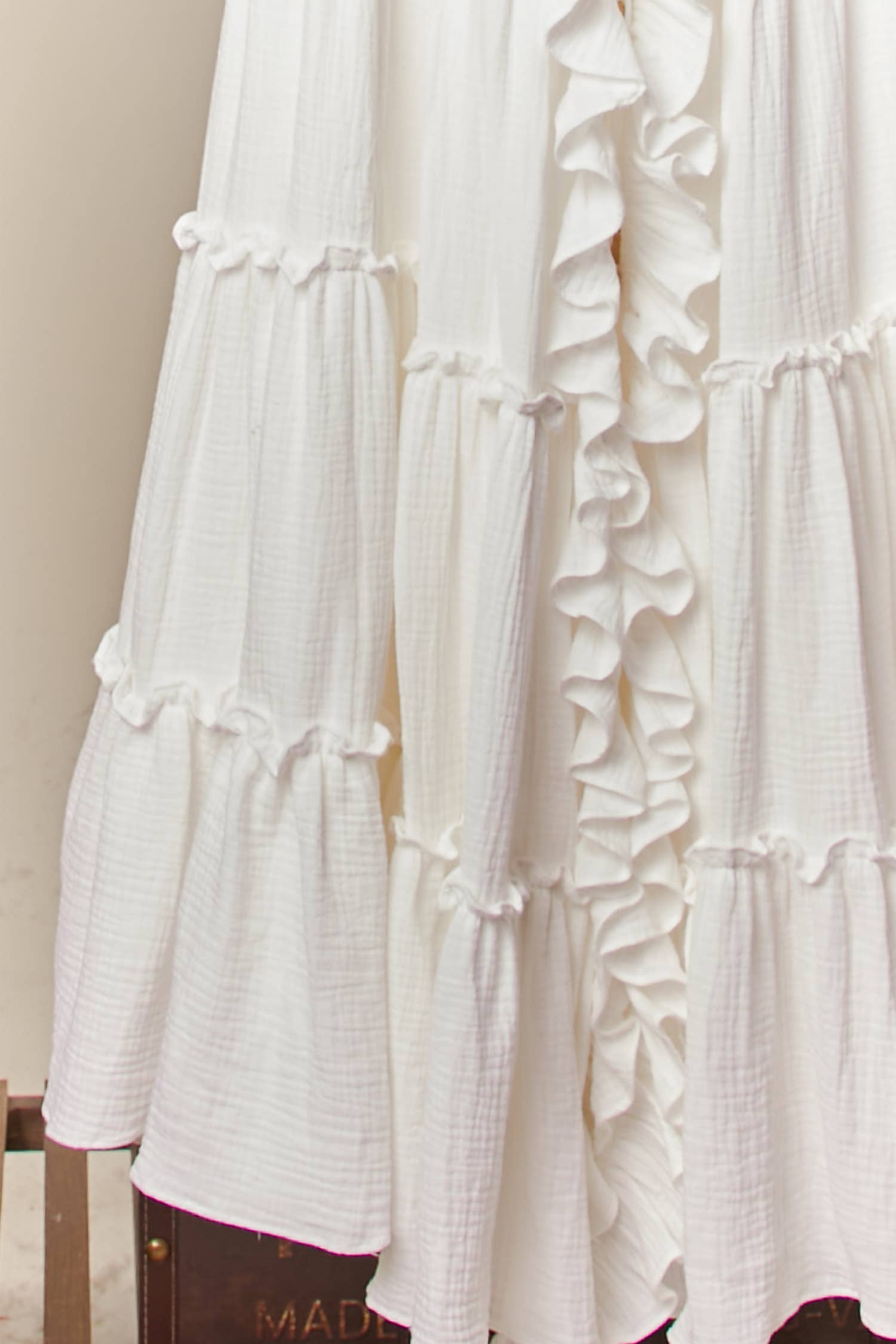  Cream ruffle cardigan dress detail - close-up of luxurious flowing fabric and cascading ruffle construction