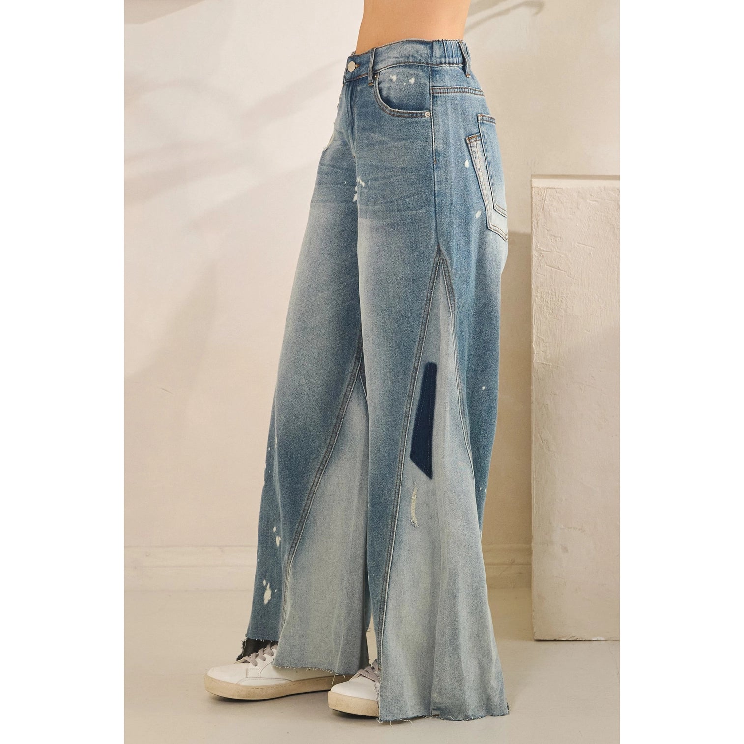 Paint Splatter Wide Leg Flare Jeans - side view showing godet flare panel construction, contrast patchwork detail and raw frayed hem