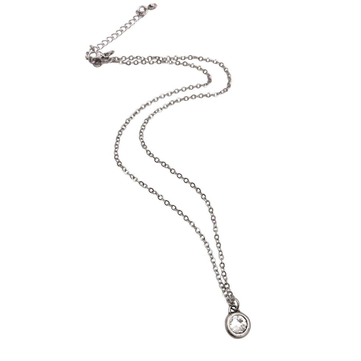 A silver-toned chain necklace with a small oval pendant featuring a clear gemstone, displayed on a plain white background.