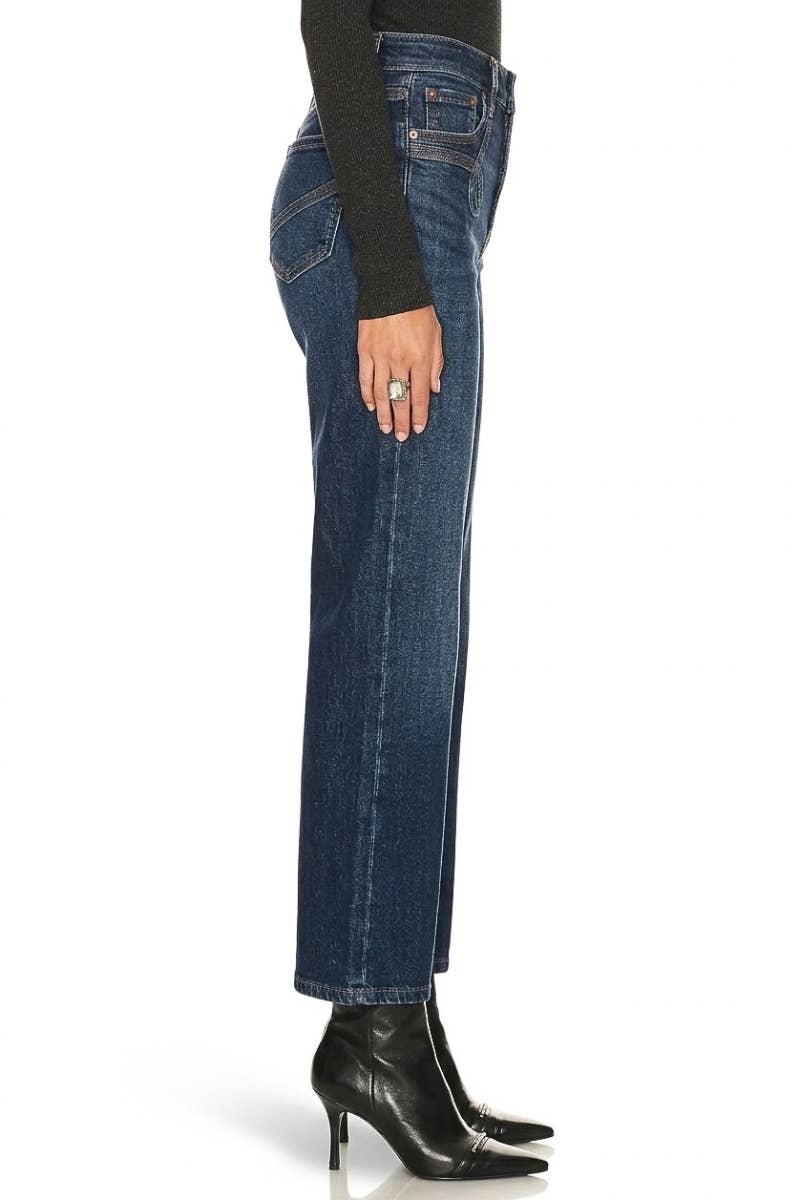 Side view of Artemis Vintage dark wash ankle straight jeans styled with black heeled boots