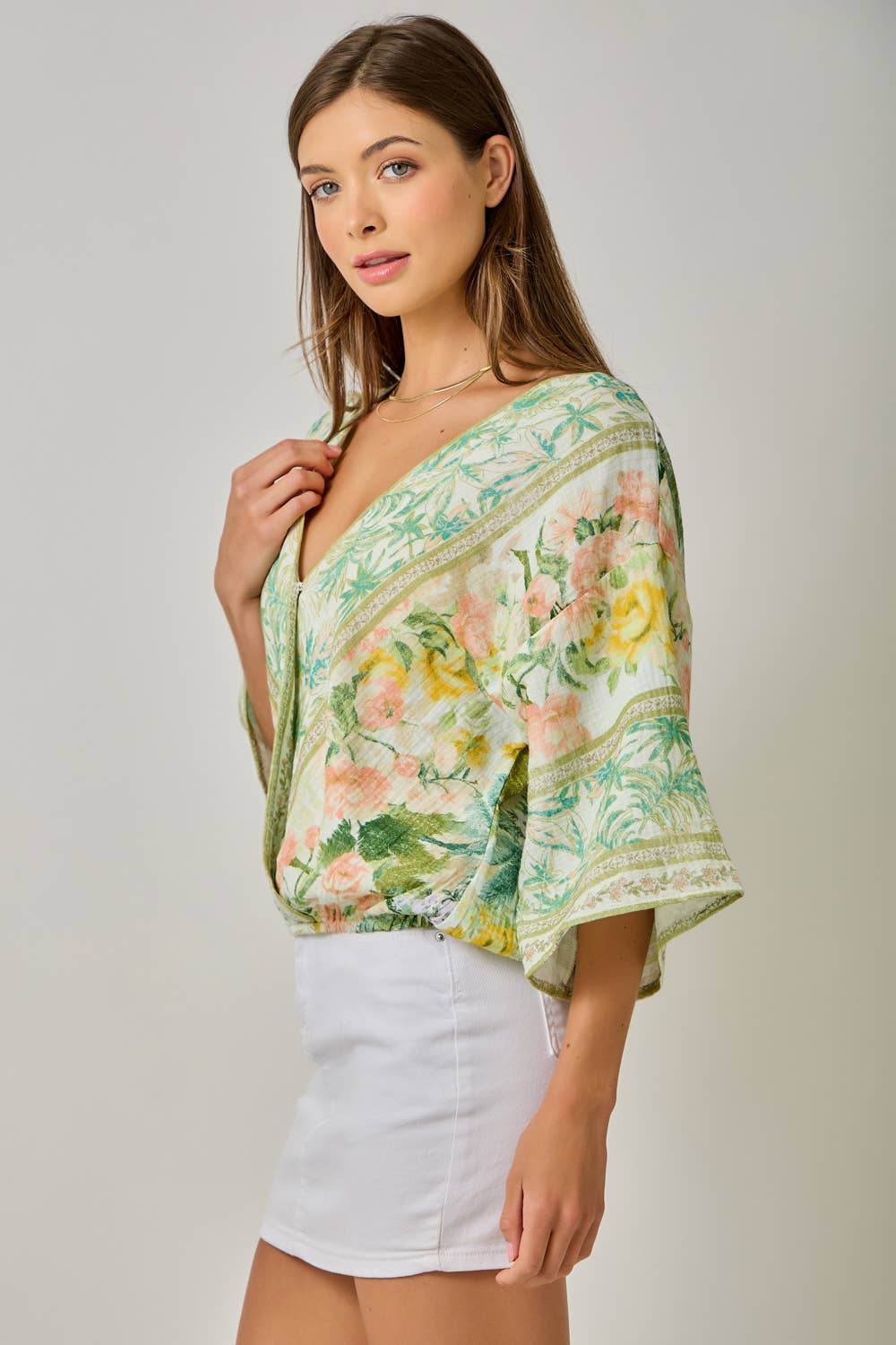 Woman wearing a floral blouse with a plain background