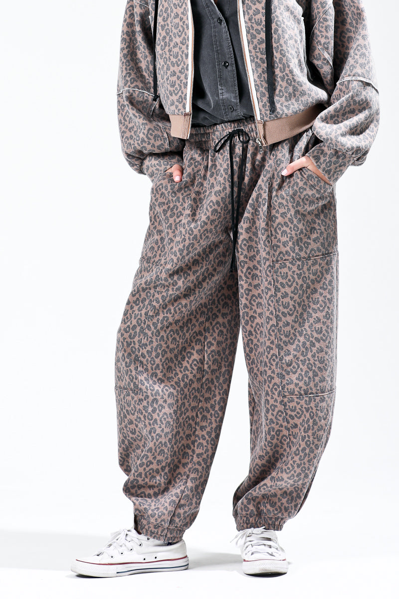 close up of Spotted & Chic Joggers in Latte Cheetah - women's relaxed fit cheetah print joggers with elastic drawstring waist and cuffed hem
