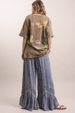 Back view of boho butterfly print mineral washed top with ruffle sleeves, paired with blue wide leg ruffle pants
