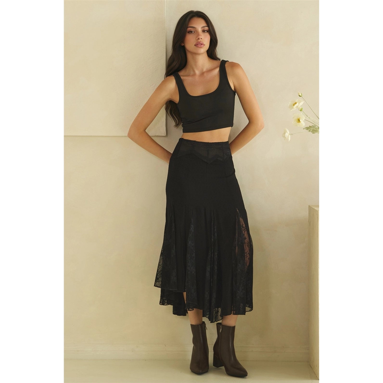 Calla Lace Godet Maxi Skirt in Black by Oli & Hali — full length front view on model, black godet skirt with structured waistband and sheer floral lace panel inserts, black crop top and boots