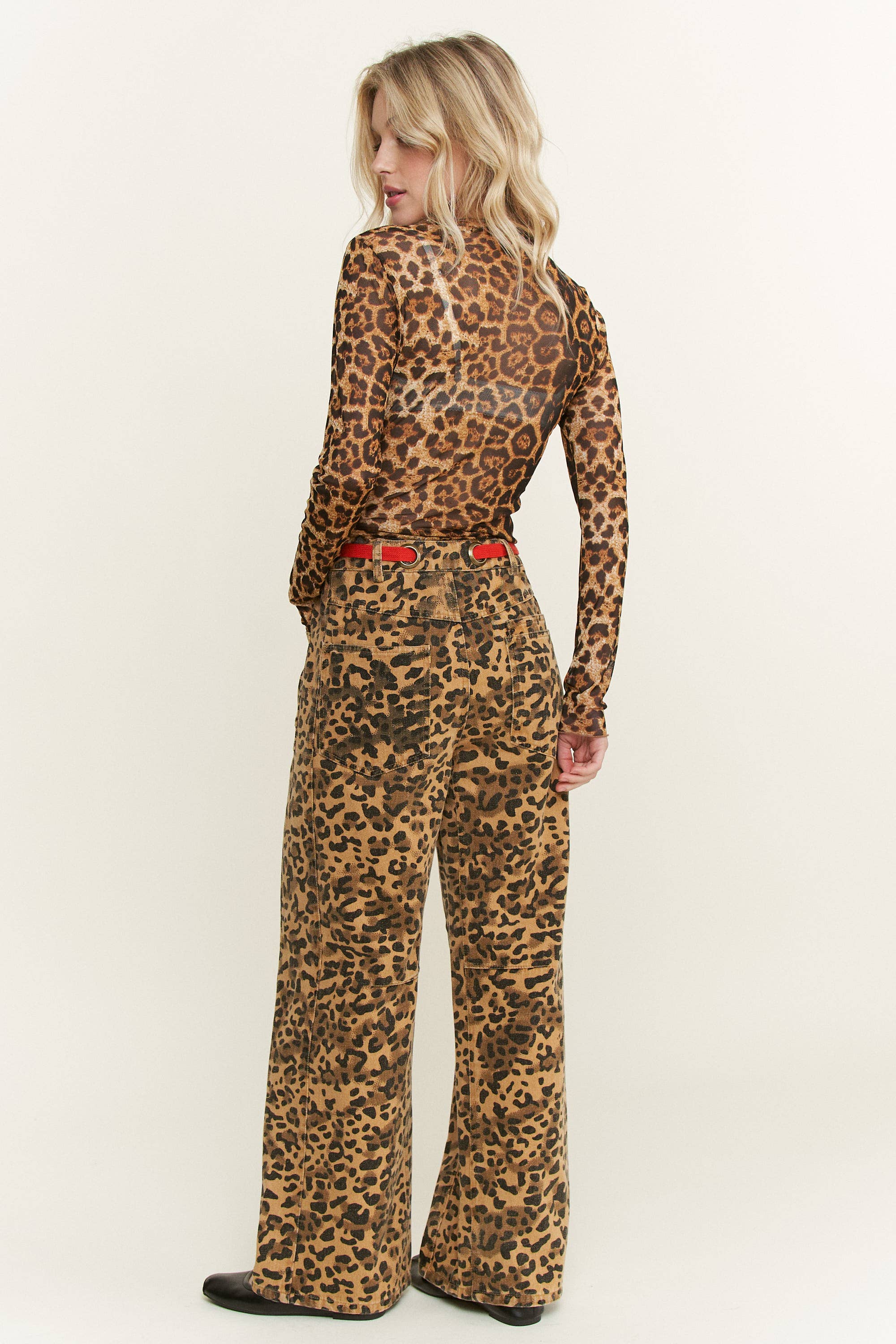 Leopard-print wide-leg pants, relaxed fit with back patch pockets and red rope belt rear angle on model.