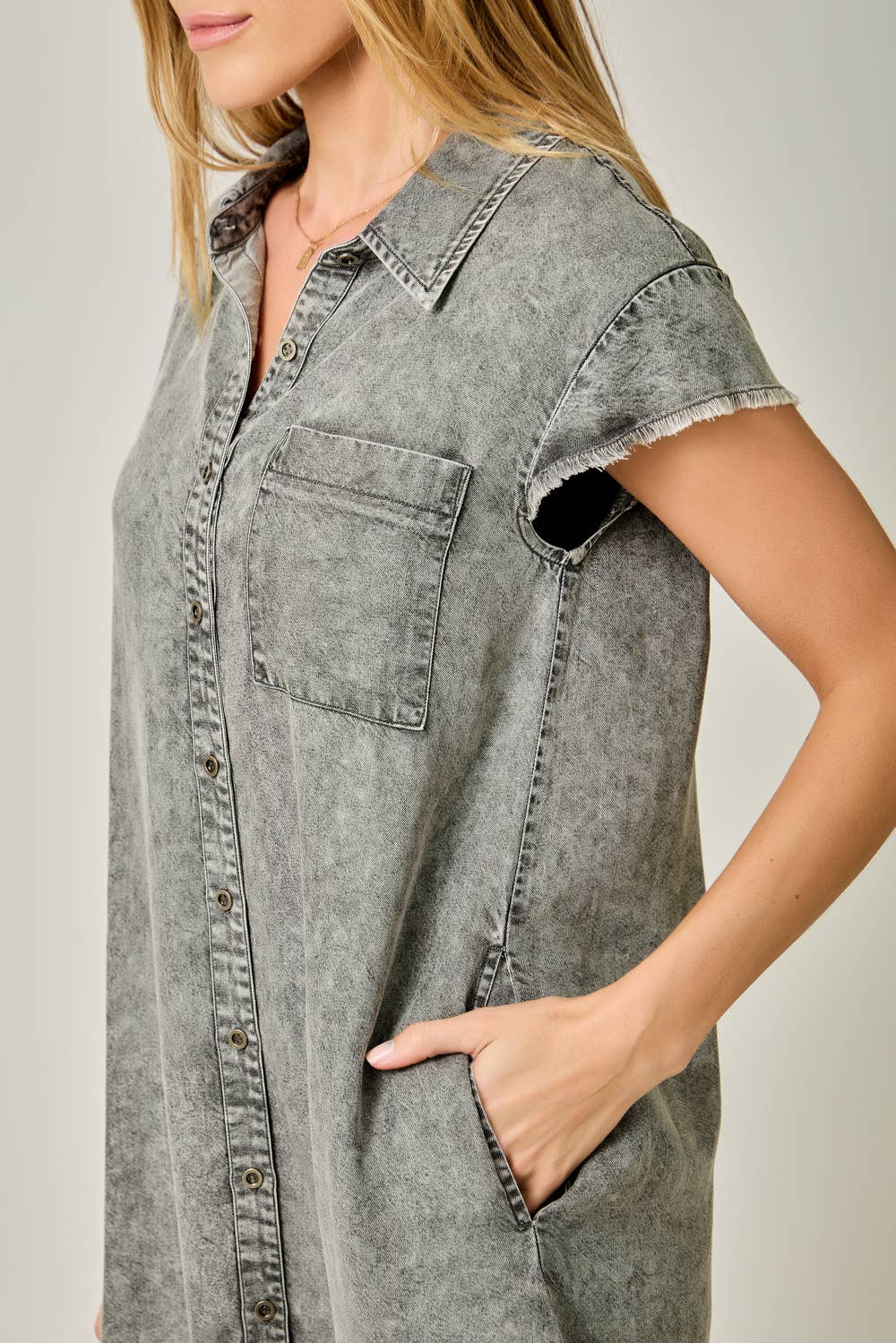 Flutter Sleeve Fringe Hem Tencel Shirt Dress in Washed Black — button-down front, flutter cap sleeves, fringed hi-lo hem, and side pockets. Close up side view