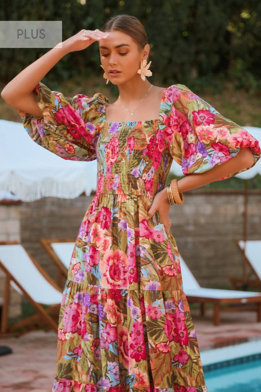 Woman wearing a floral dress by a poolside