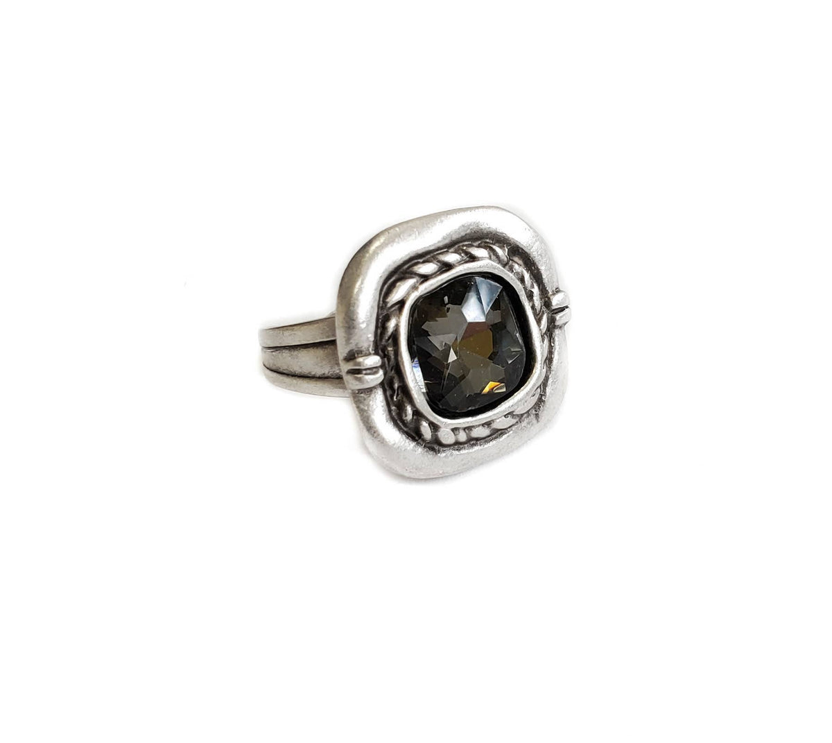 A silver-toned ring featuring a large, square-shaped dark brown gemstone with a textured, rope-like border and a polished band, shown on a plain white background.