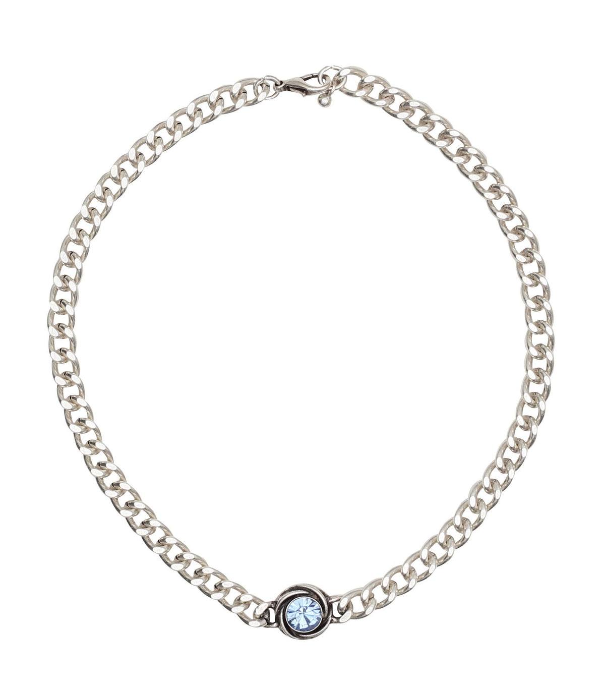 A silver-toned curb chain necklace with a small bezel-set light blue round gemstone at the front, displayed on a clean white background.