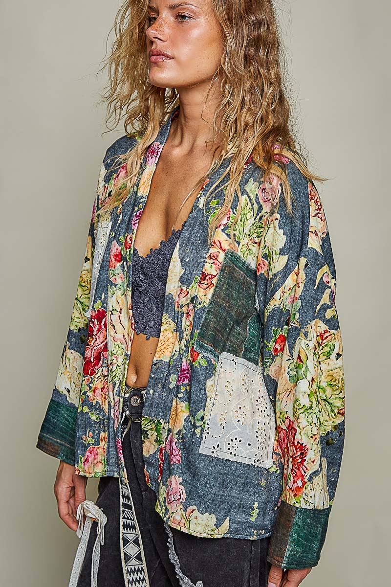 Side view of a woman wearing the Peace in Bloom green floral and plaid reversible jacket
