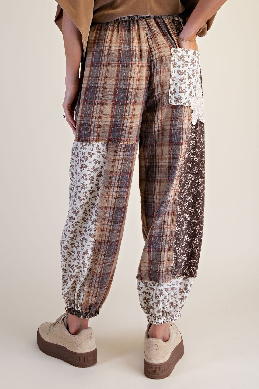 Back view THISTLE & THREAD patchwork jogger pants with a lace-trimmed drawstring waist
