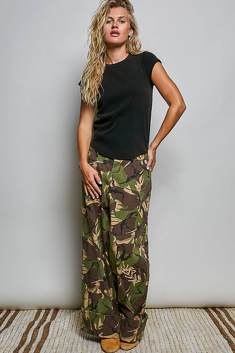 Black artisan stitch curved hem knit top, full-length front view styled with camo cargo pants and sneakers 