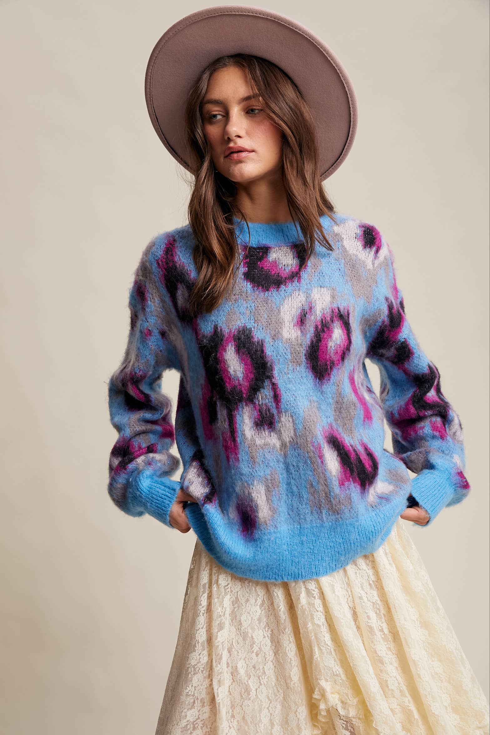Close up of Women’s fuzzy abstract leopard knit pullover sweater with soft textured fabric and bold animal print — cozy statement top for modern chic outfits. Front View