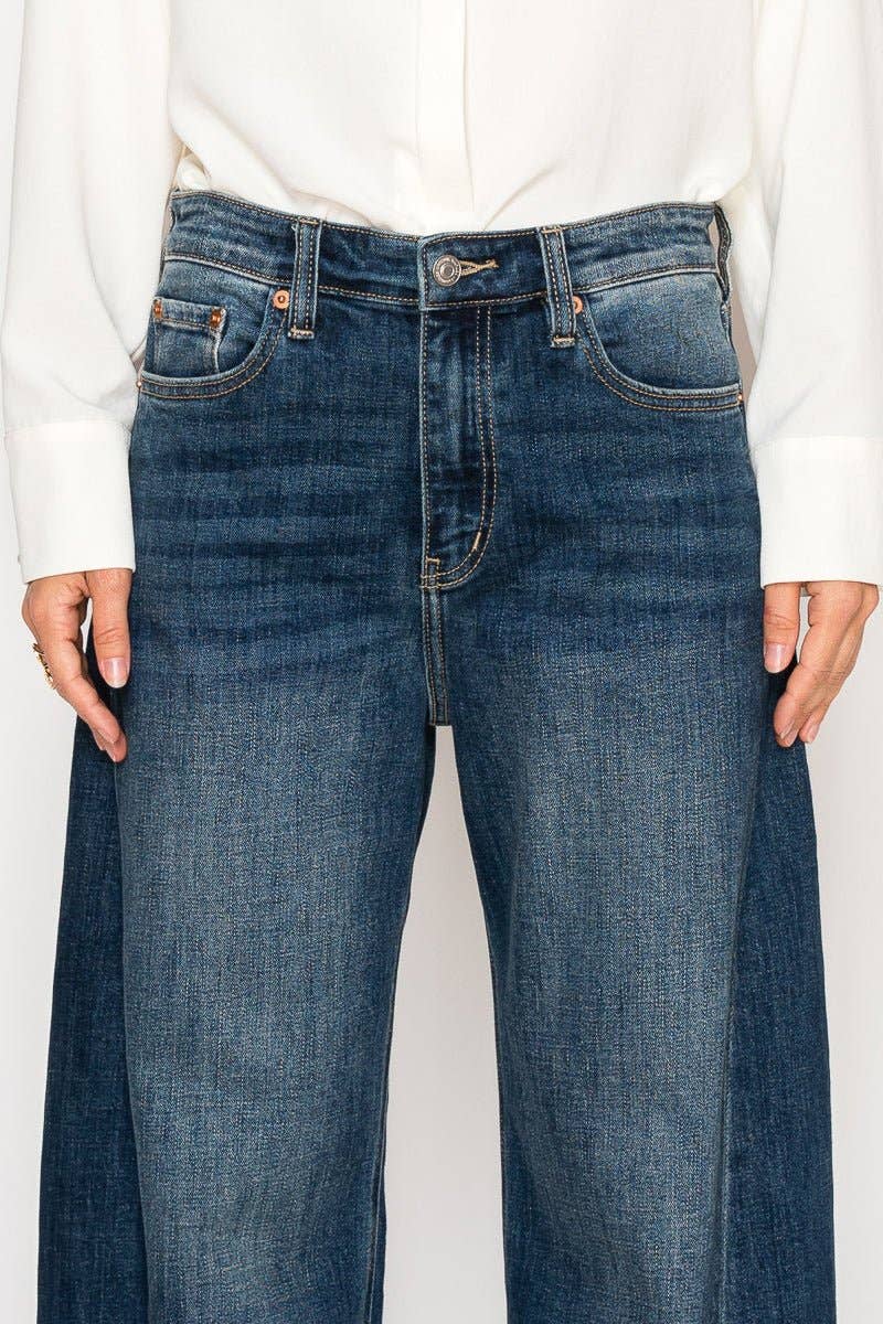 Blue jeans worn by a person on a white background
