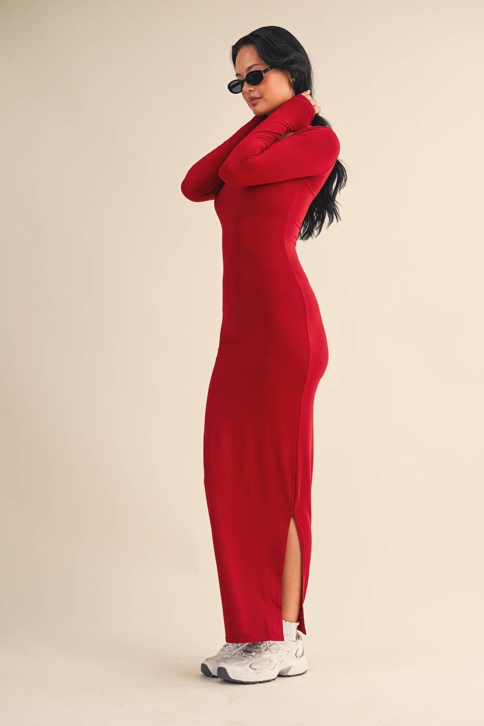 Side view of Woman wearing red square-neck long sleeve maxi dress in buttery knit fabric by Kimberly C.