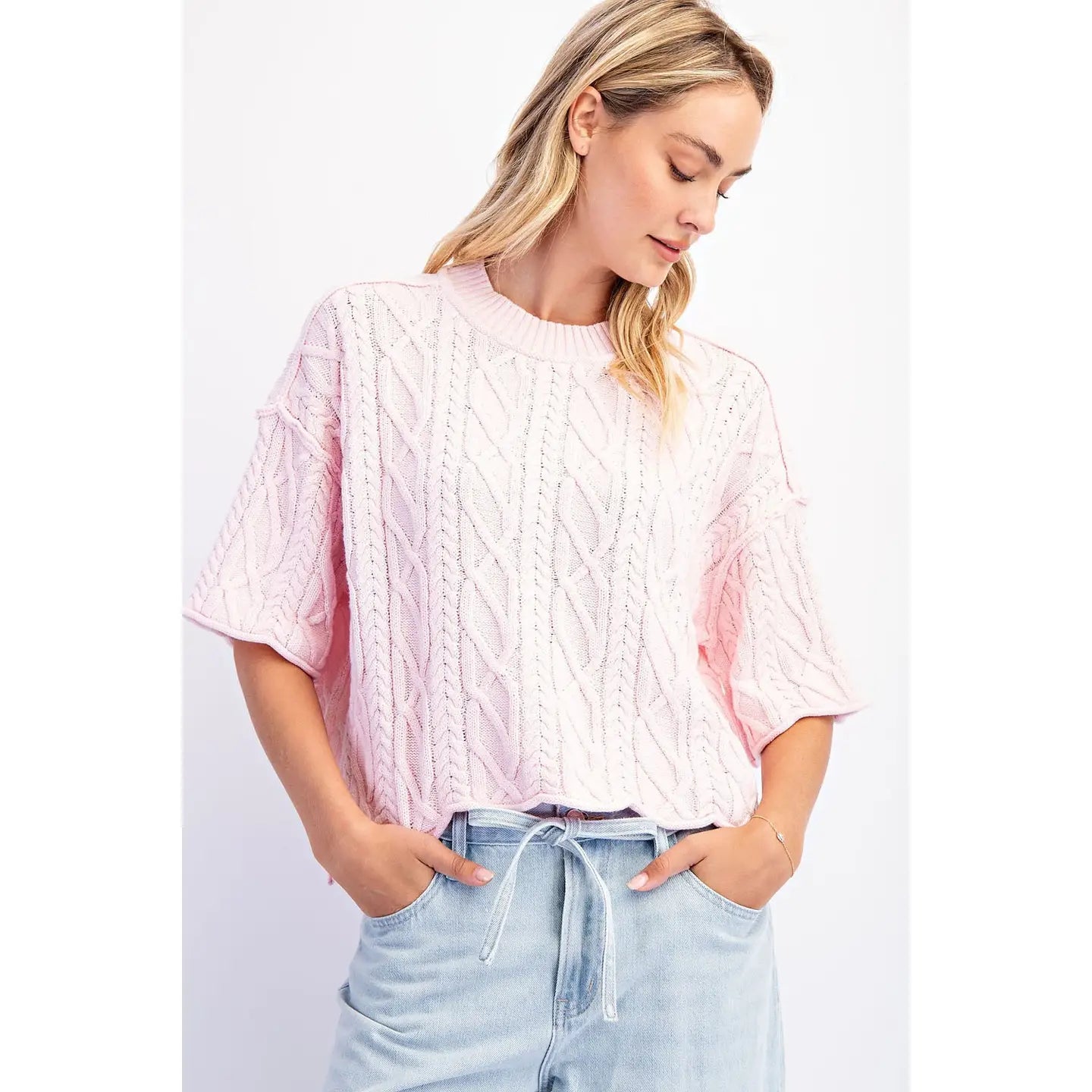 The Cove Oversized Sweater in Baby Pink — front view, slouchy cable knit with dropped shoulders and asymmetrical hem in pink