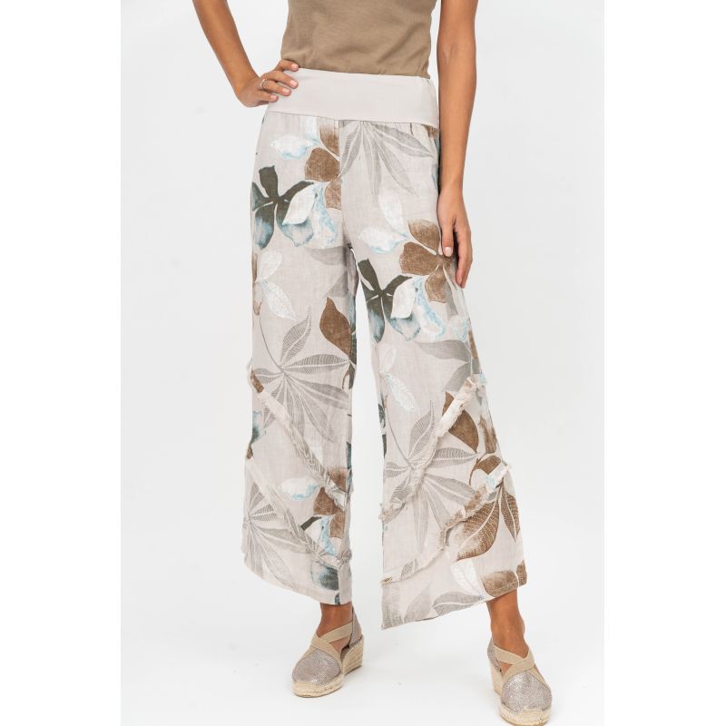 Floral-patterned pants worn by a person on a white background