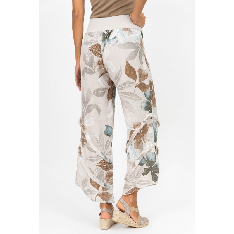 Floral-patterned pants worn by a person on a white background